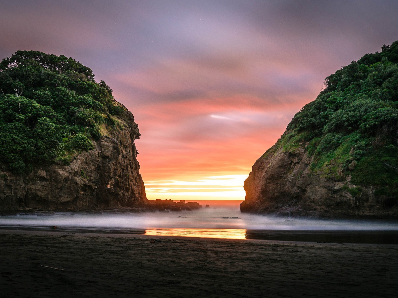 Beautiful sunset between rocks in New Zealand