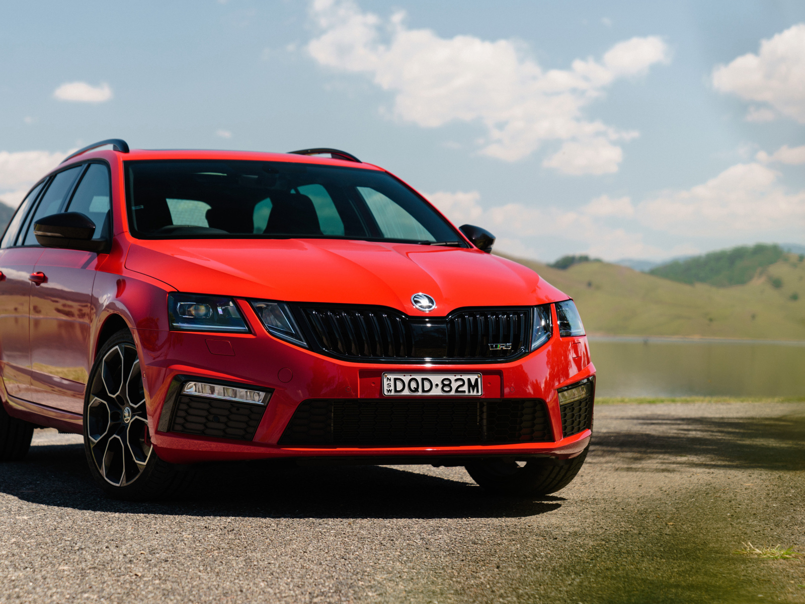 Quick red car Skoda Octavia RS 245 Wagon on the sky background