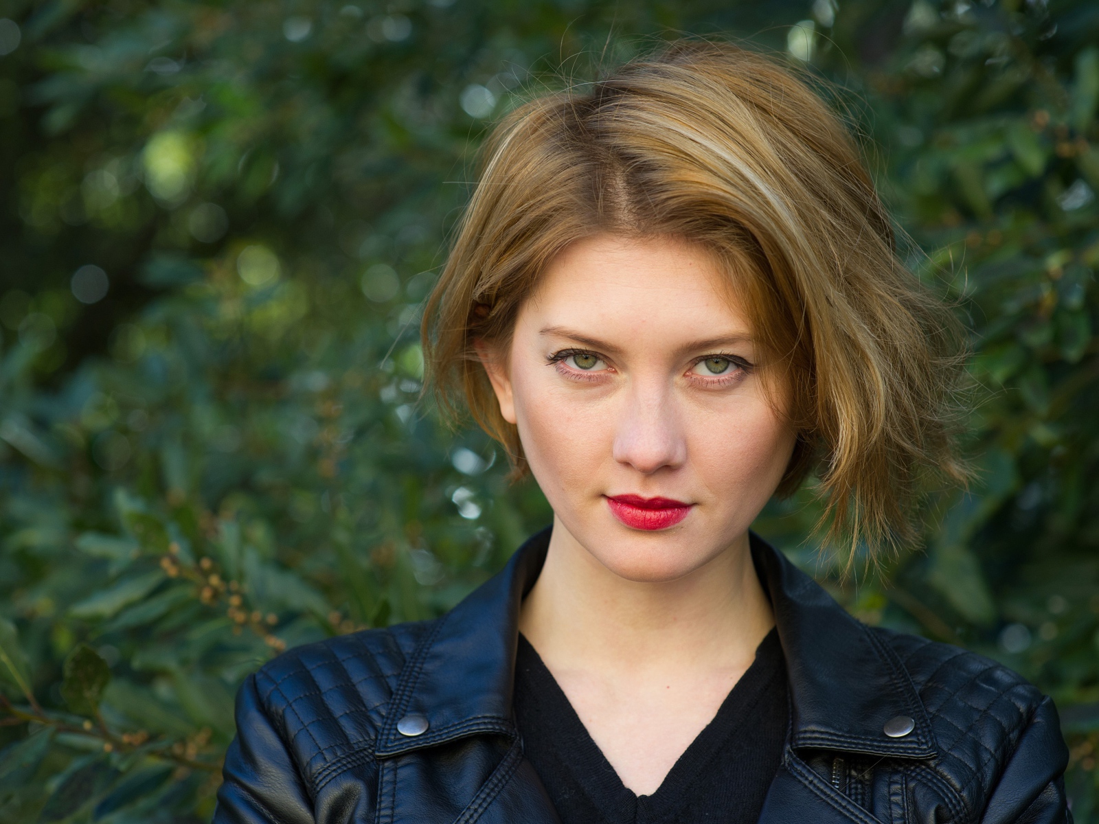 Красивая девушка с короткой стрижкой в кожаной куртке