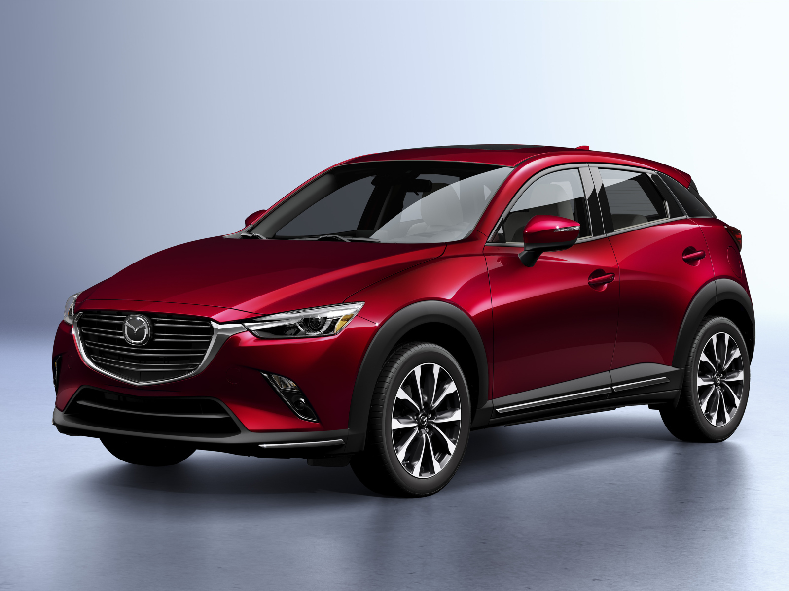 Бордовый внедорожник Mazda CX-3, 2019 года на сером фоне