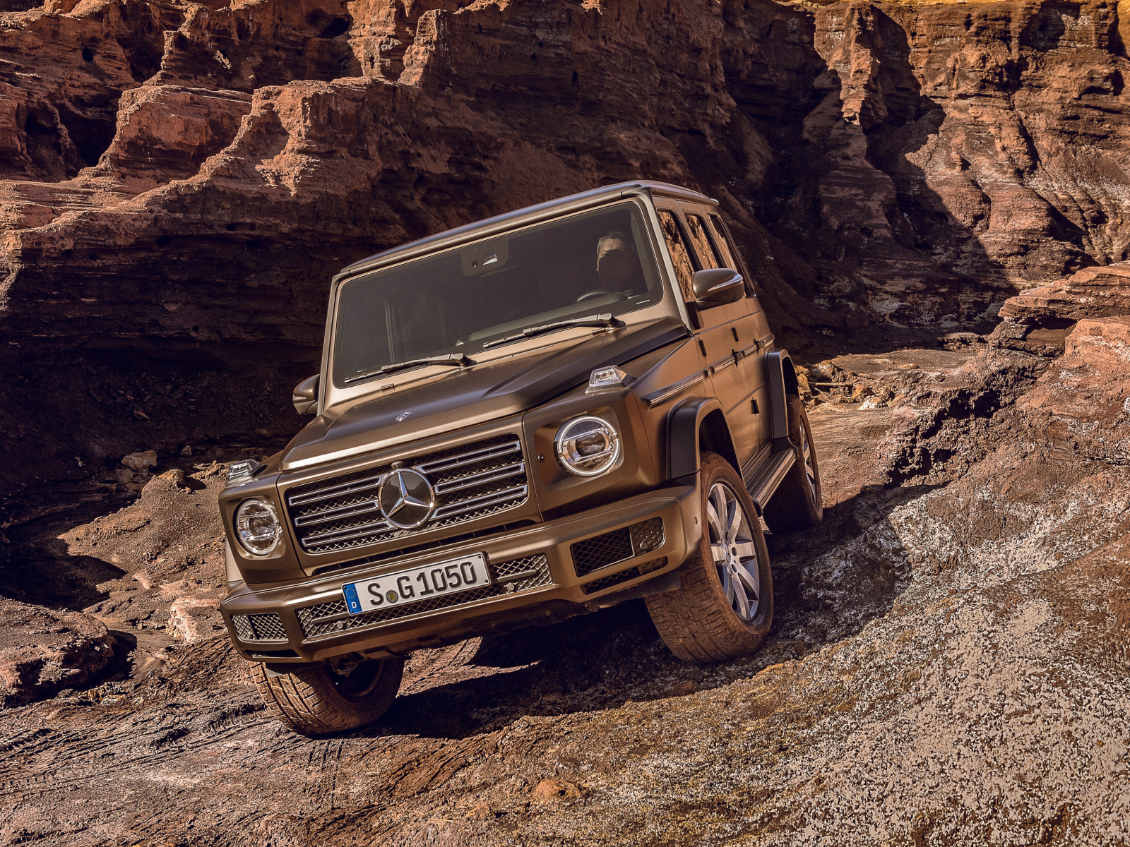 The big expensive car is Mercedes Benz G 500, 2018 in the mountains
