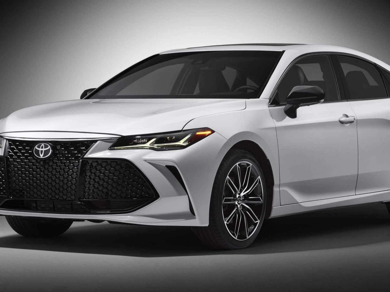 Белый автомобиль Toyota Avalon 2019 на сером фоне