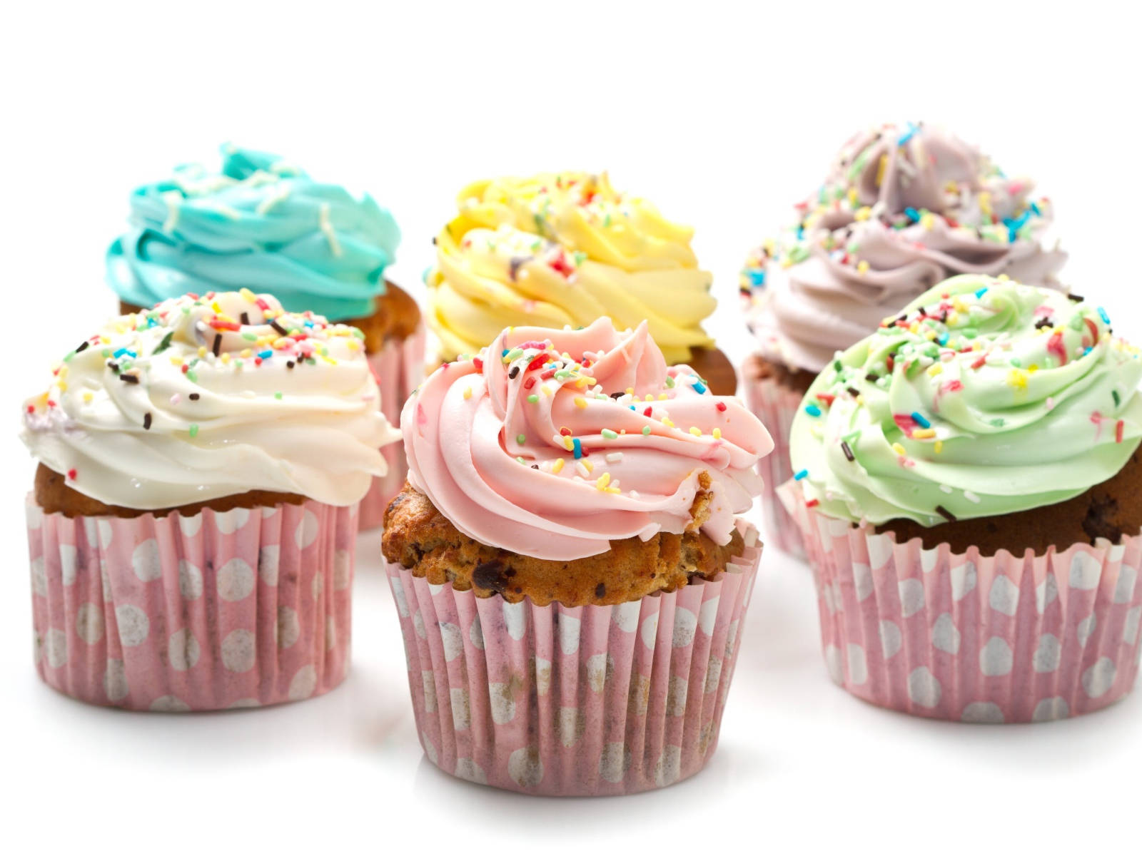 Аппетитные капкейки с кремом на белом фоне