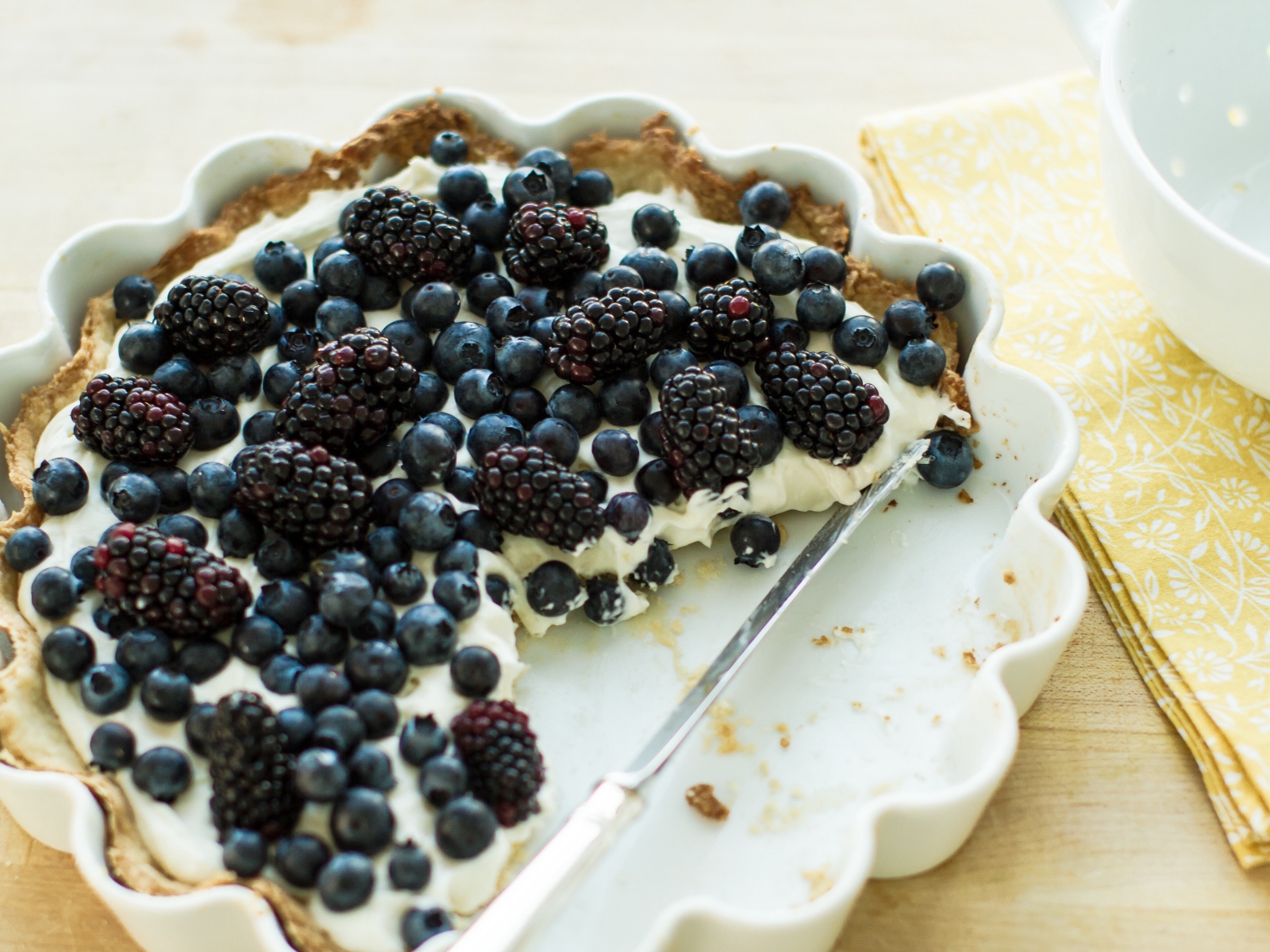 Cake with cream and berries of blueberries and blackberries