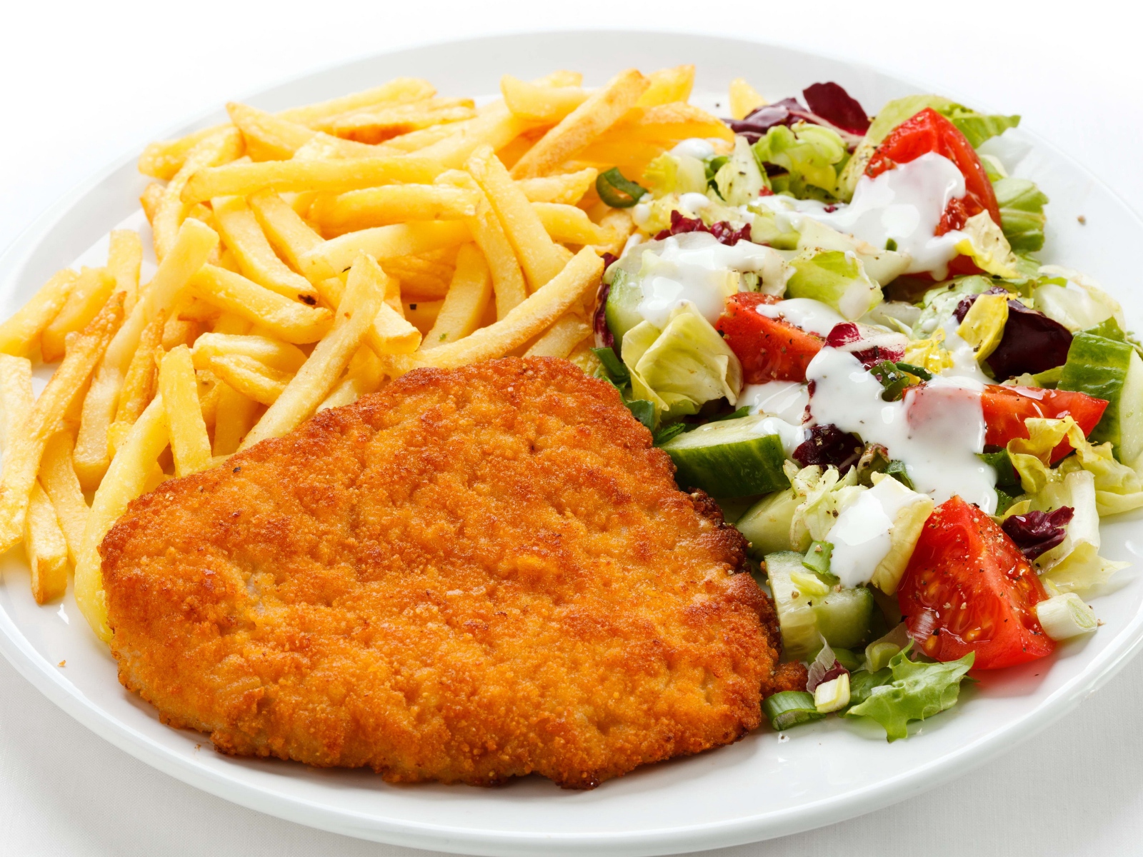 Отбивная на тарелке с картофелем фри и салатом