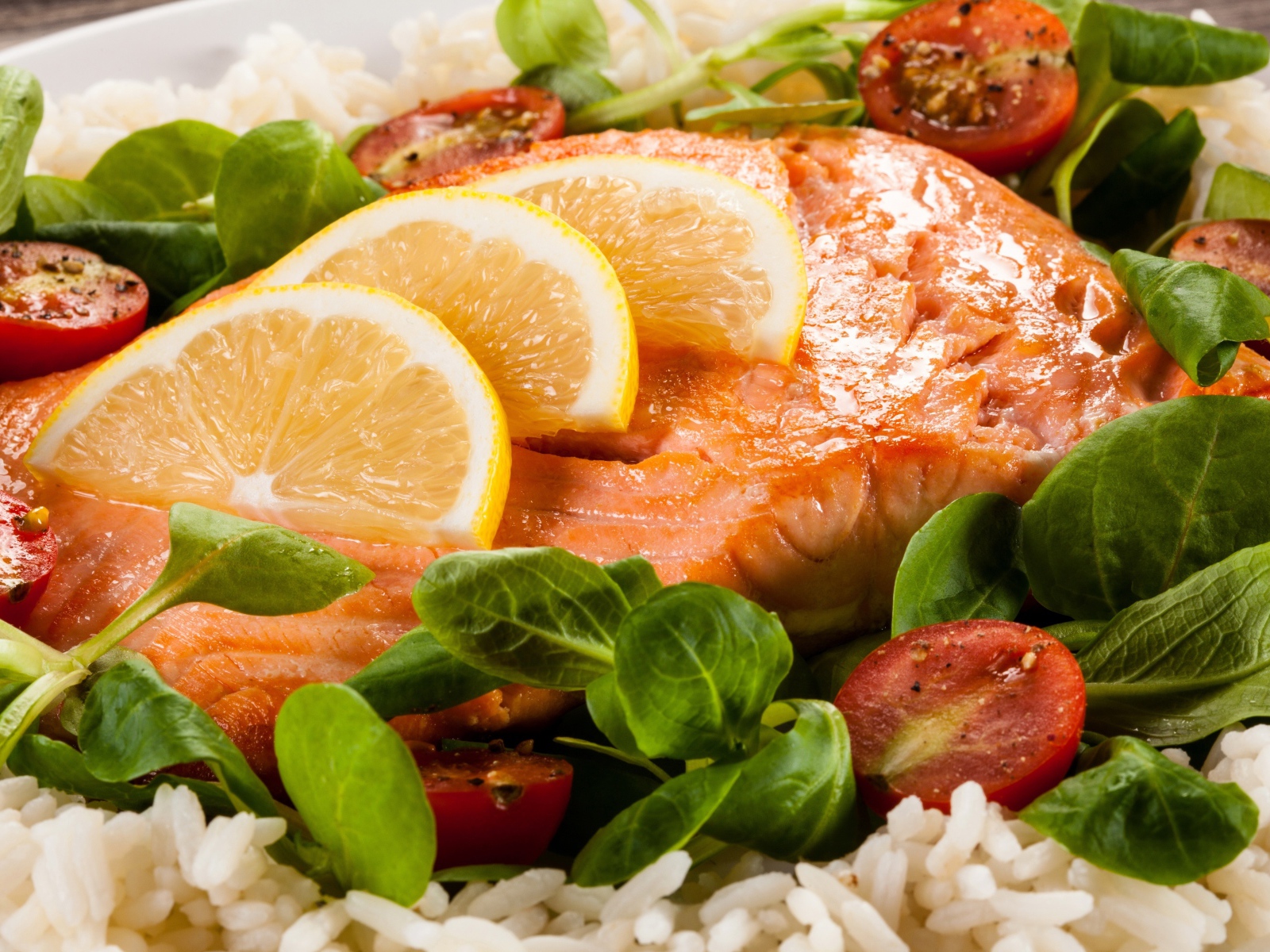 Жареная красная рыба с лимоном, помидорами, шпинатом и рисом