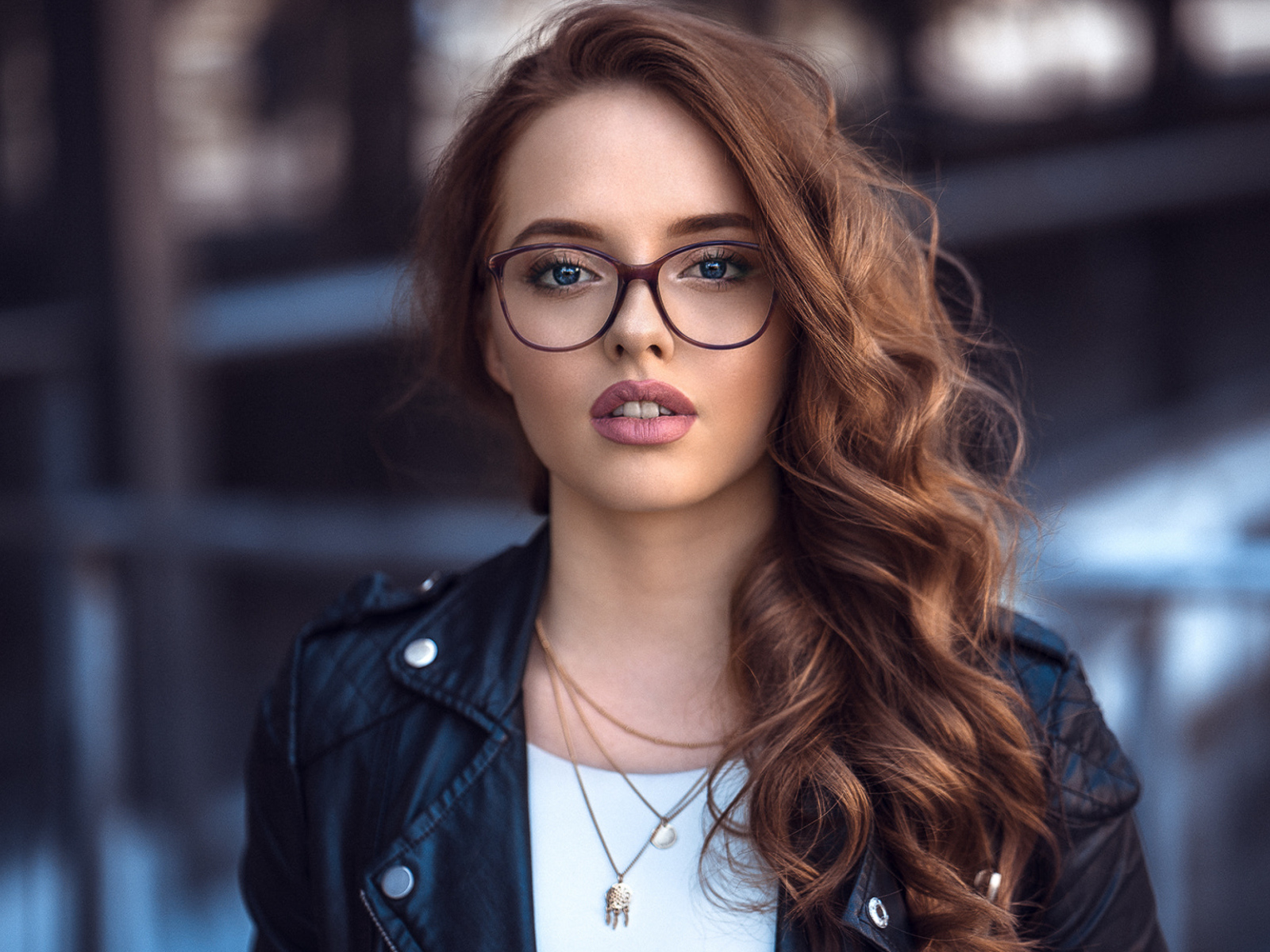 Girl in a black jacket with glasses