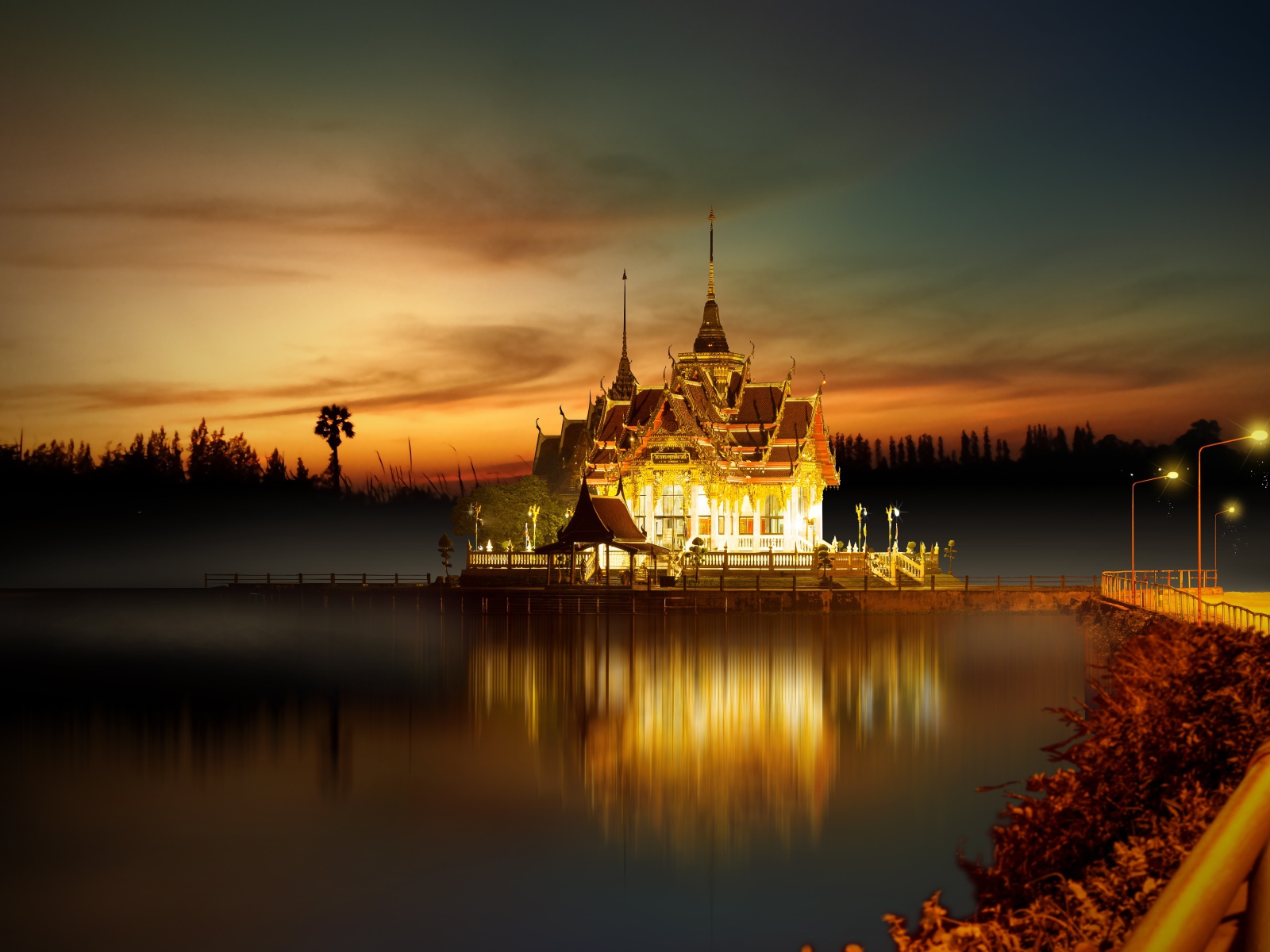 Buddhist temple by the water at night, Asia