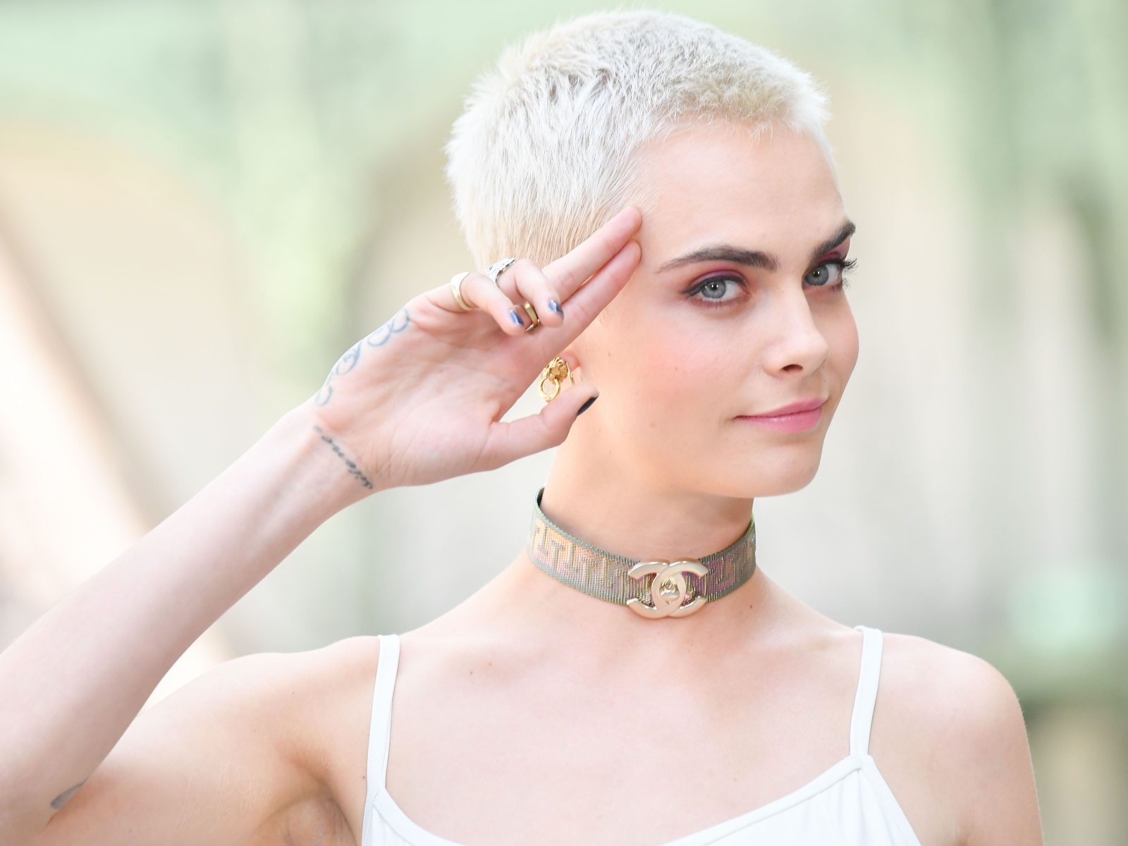 Актриса Кара Делевинь с короткой стрижкой и татуировкой на руке