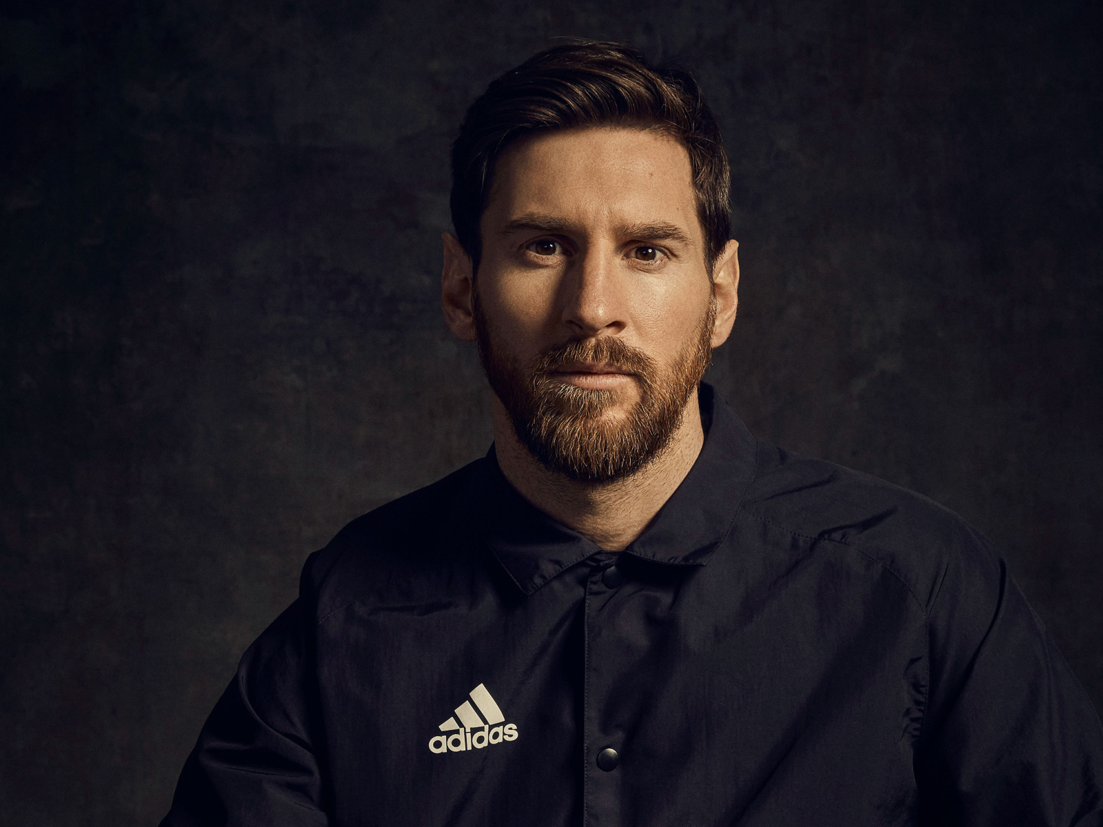 Football player Lionel Messi in a black shirt with a beard