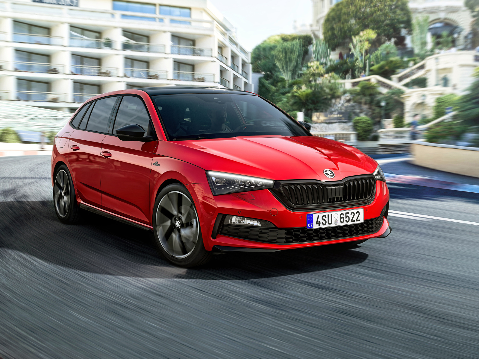 Красный автомобиль Skoda Scala Monte Carlo 2019 года на дороге