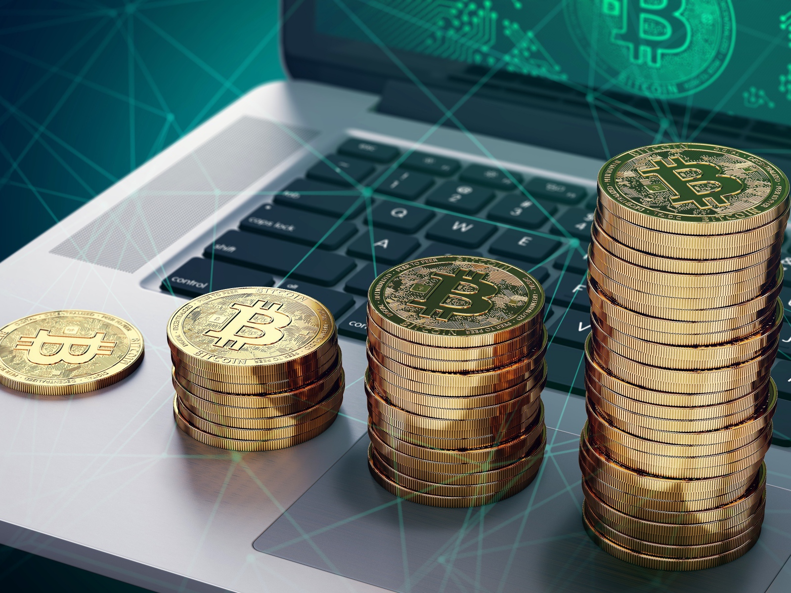Bitcoin gold coins lie on a laptop