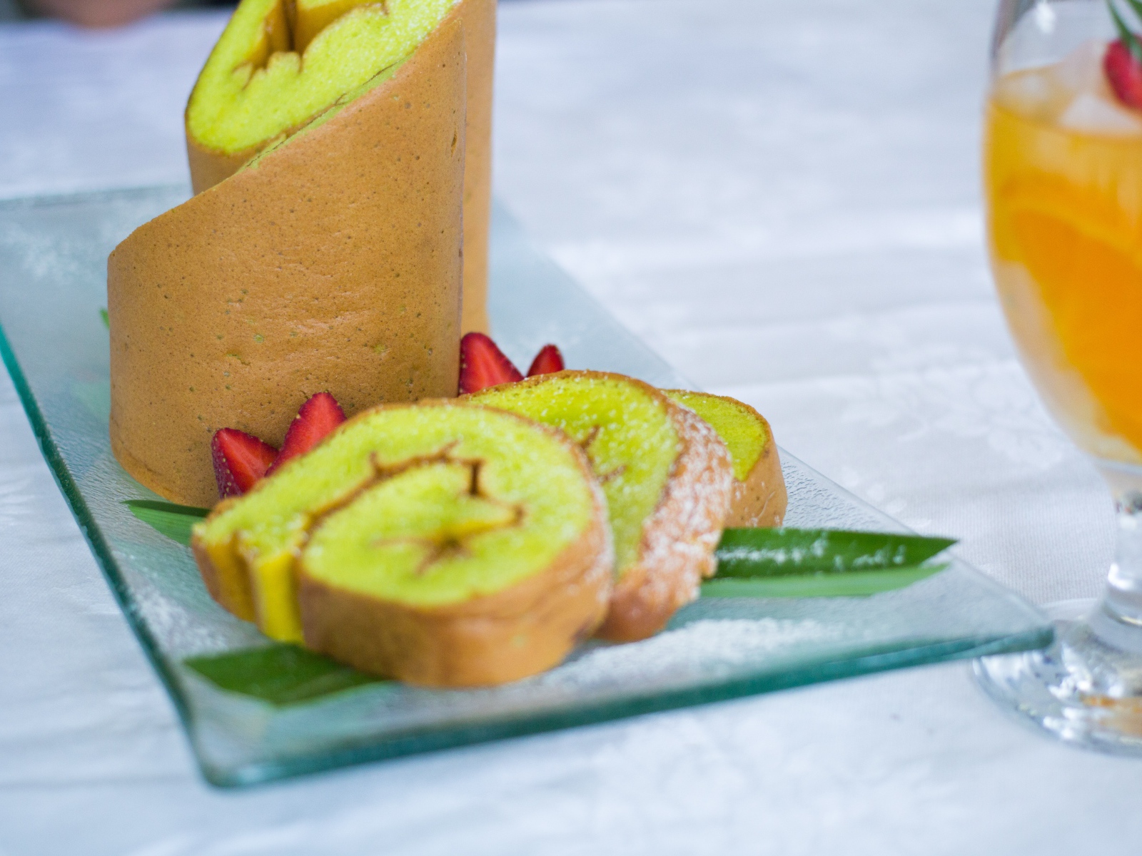 Рулет с сахарной пудрой и клубникой на столе