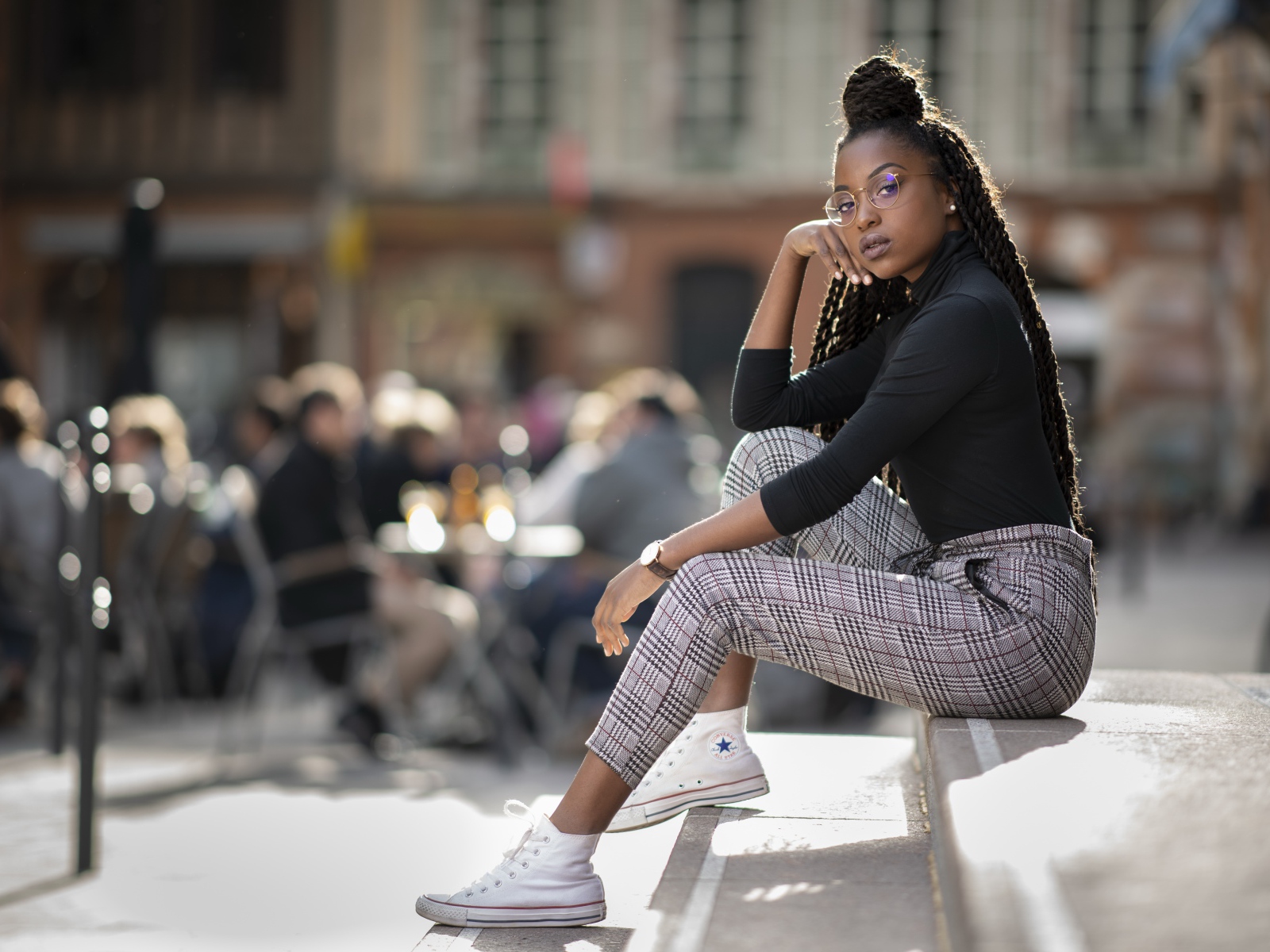 Красивая темнокожая девушка сидит на ступеньках