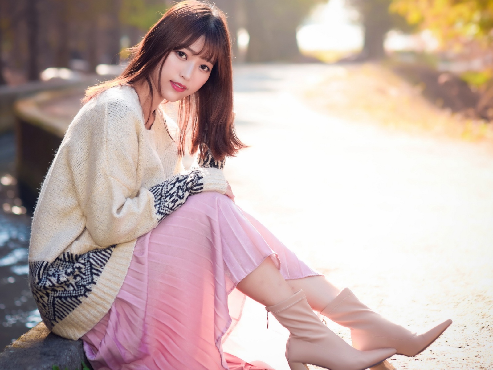 Девушка азиатка сидит на земле 