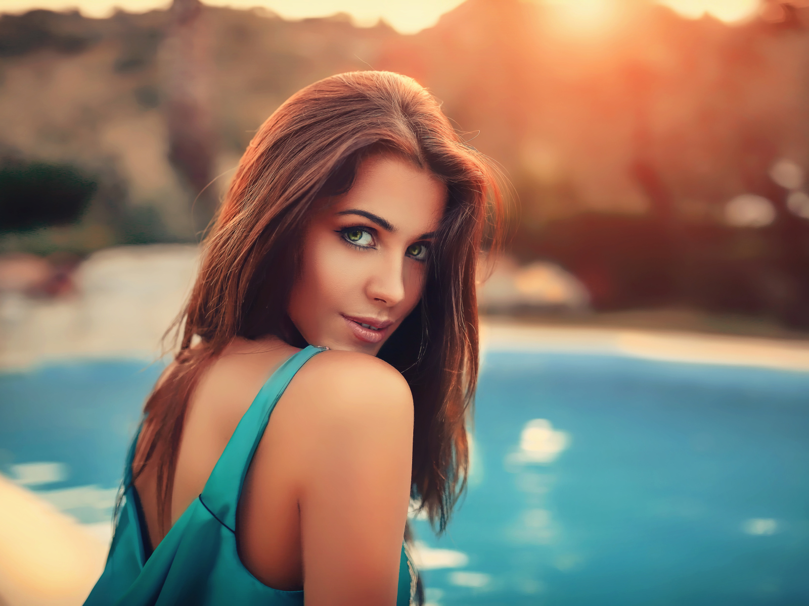 Красивая зеленоглазая шатенка у бассейна