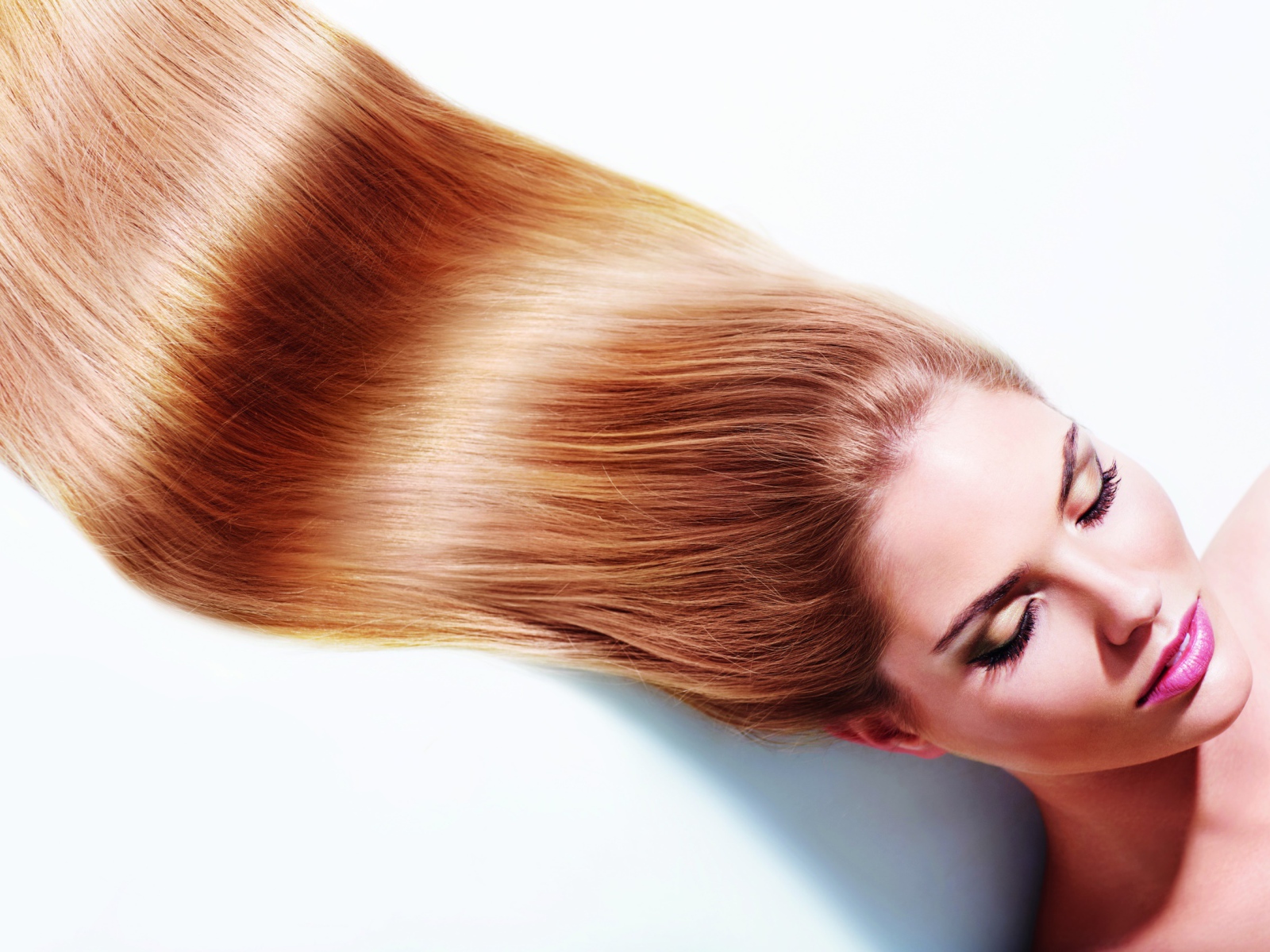 Длинноволосая шатенка с закрытыми глазами на белом фоне