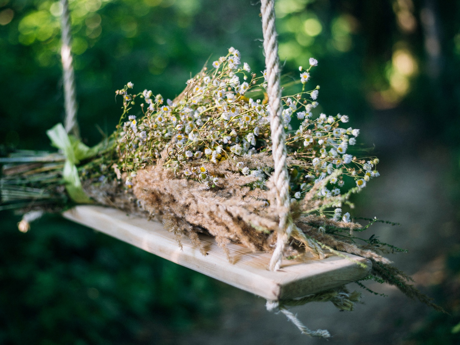 Букет полевых цветов на лежат на качели