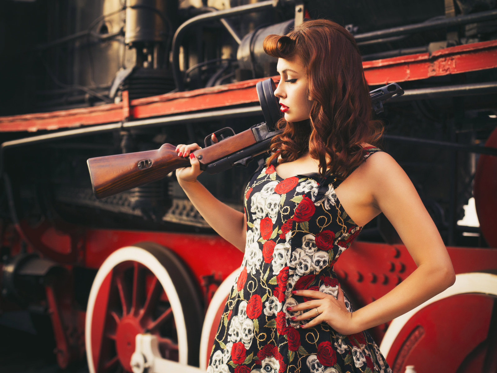 Девушка ретро с автоматом в руке  у тепловоза 