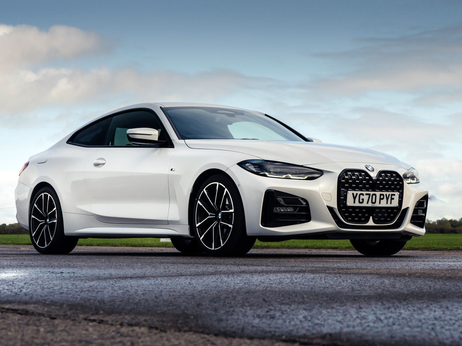 Белый автомобиль BMW 420i Coupé M Sport 2020 года на фоне неба