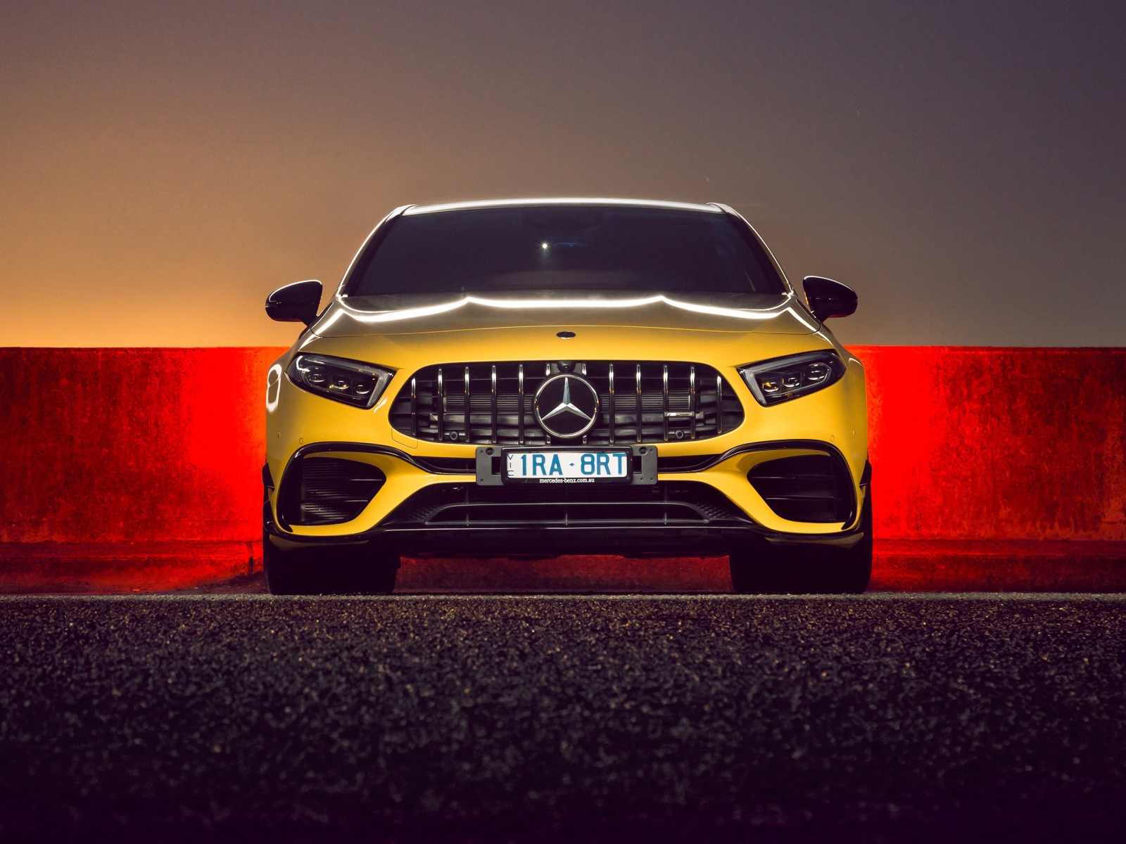 Желтый автомобиль Mercedes-AMG A 45 S,  2020 года вид спереди