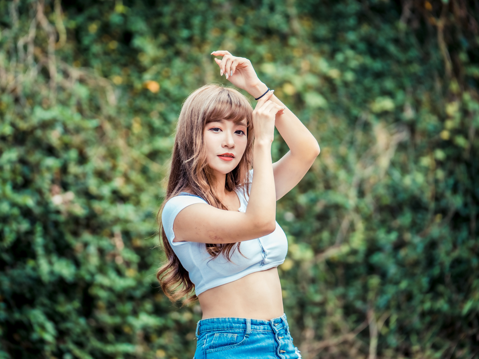 Молодая азиатка подняла руки вверх 