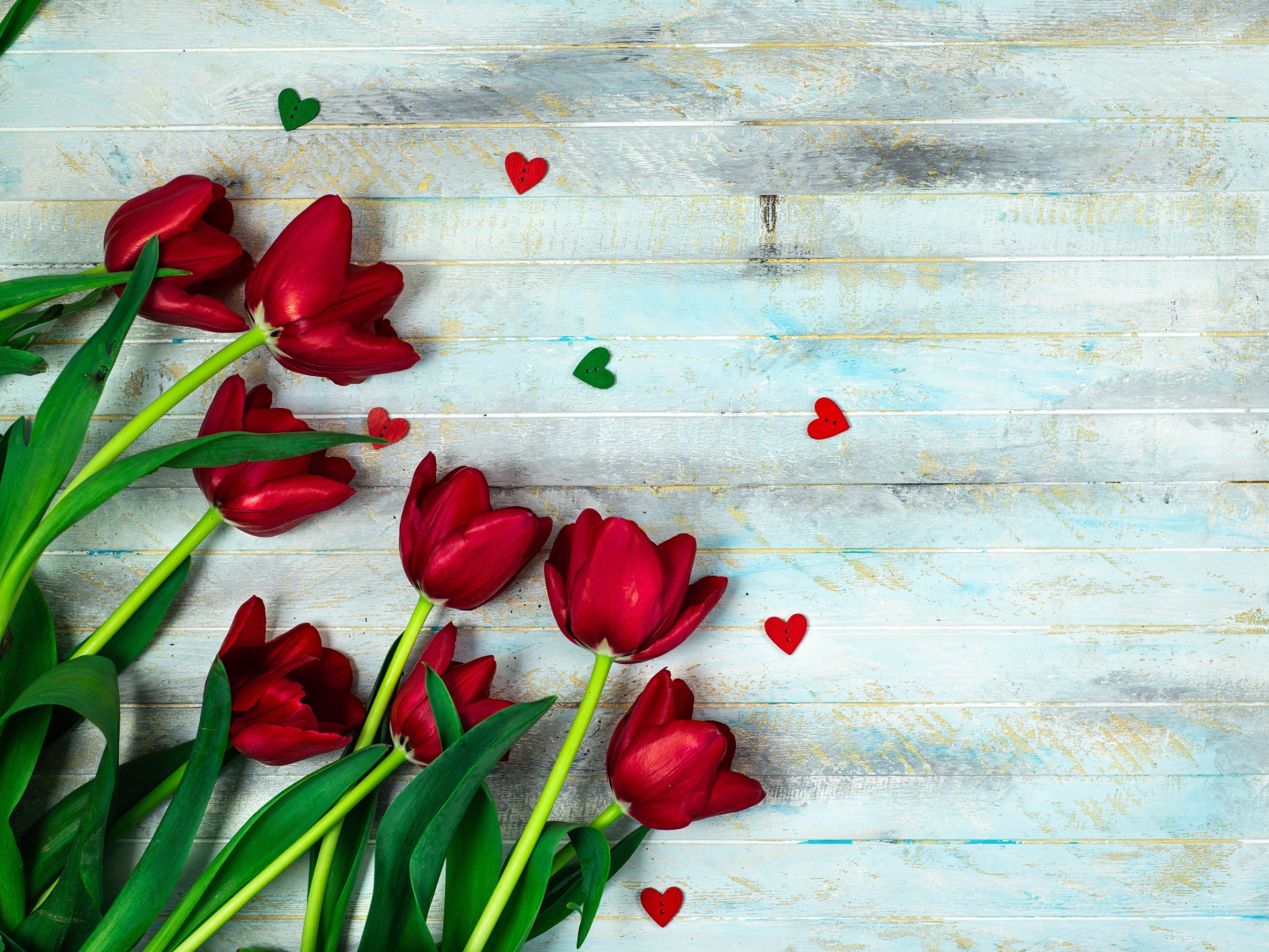 Букет красных тюльпанов на деревянном столе