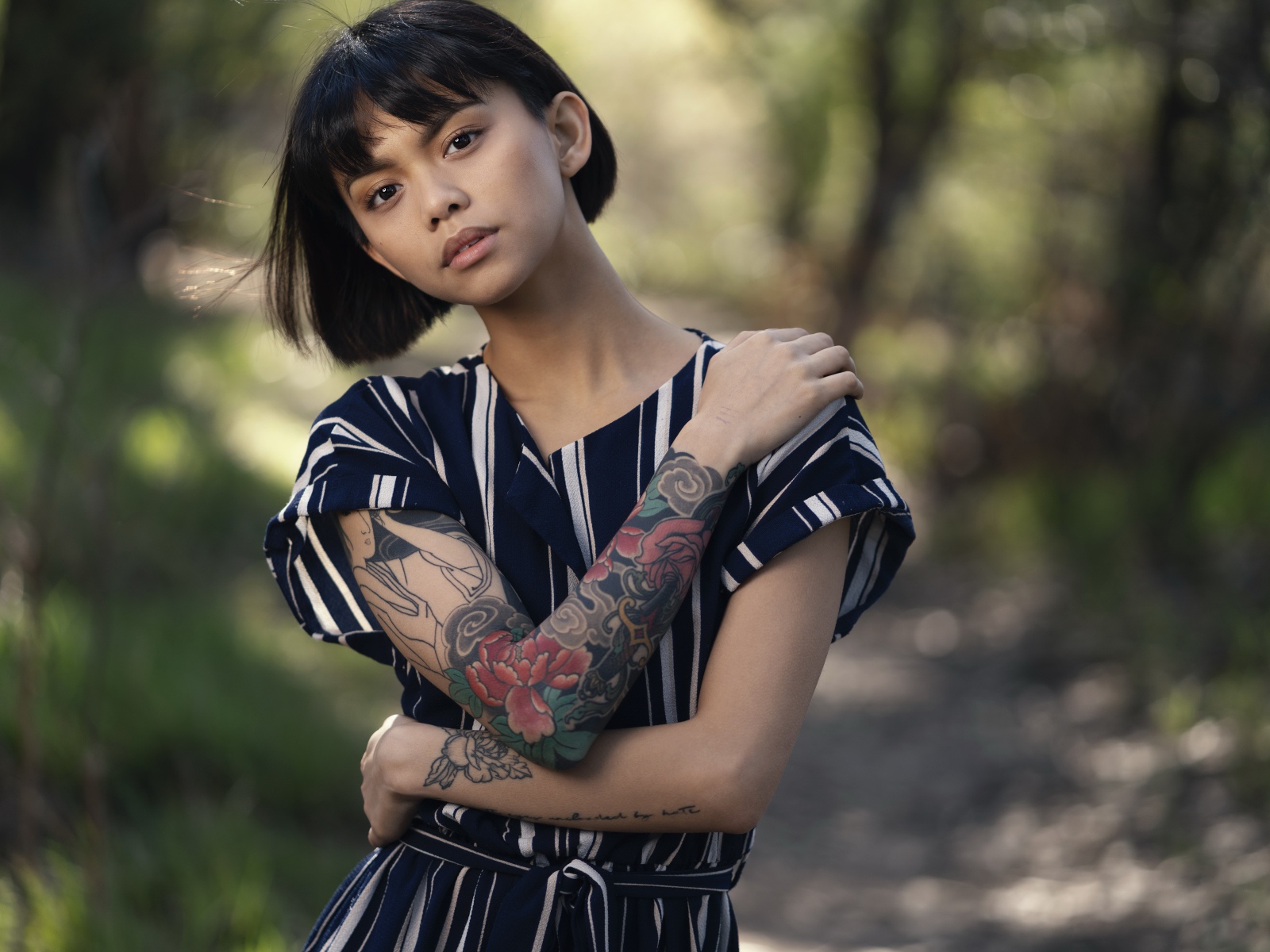 Красивая девушка азиатка с татуировками на руках 
