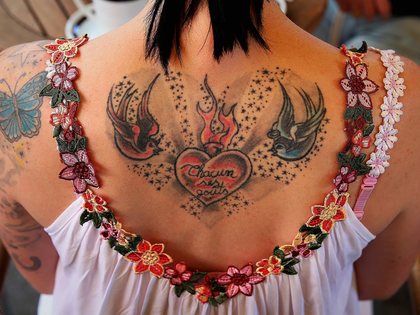 Large tattoo on the back of a girl in a white dress