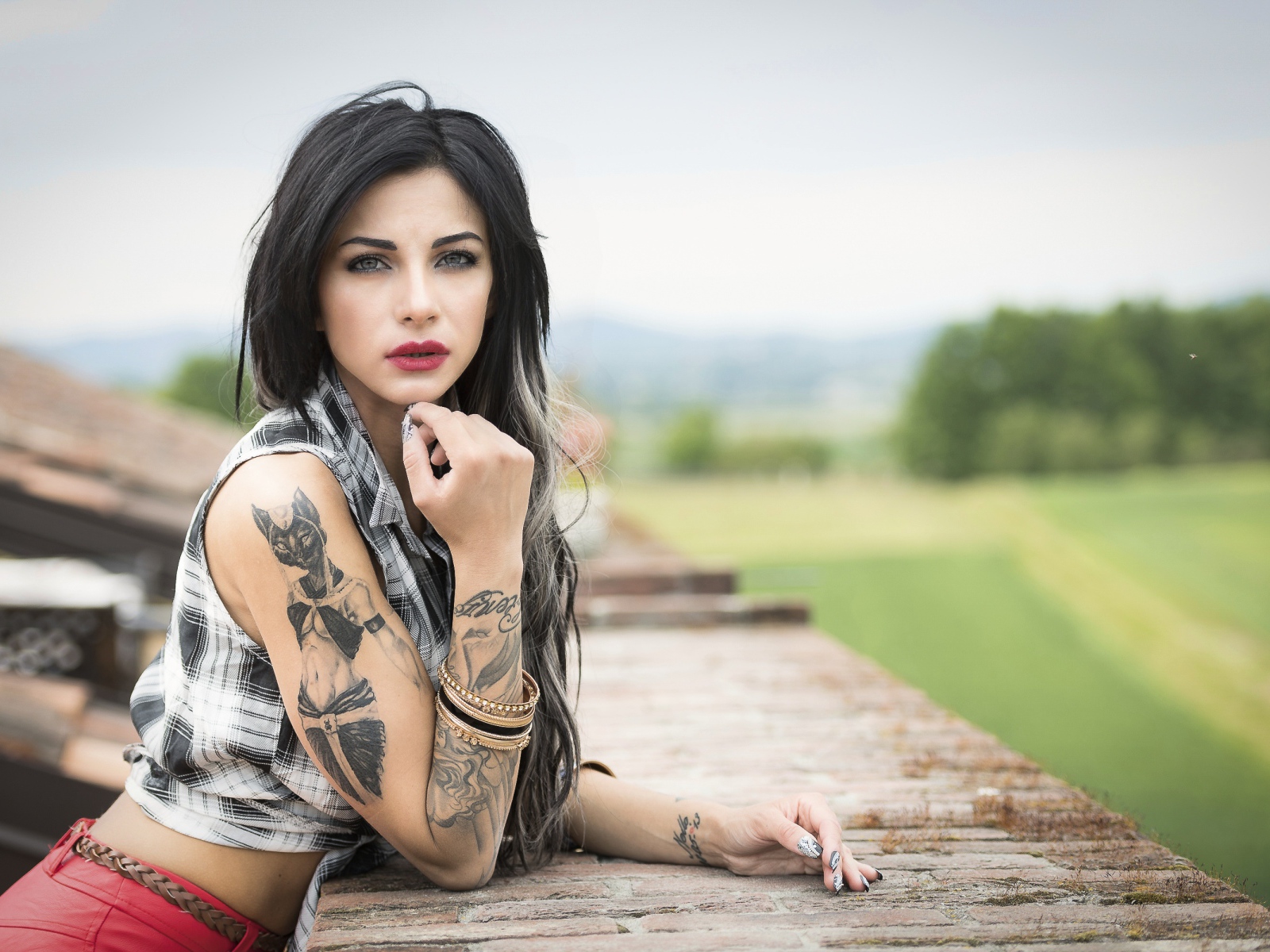 Young brunette girl with tattoos in her arms