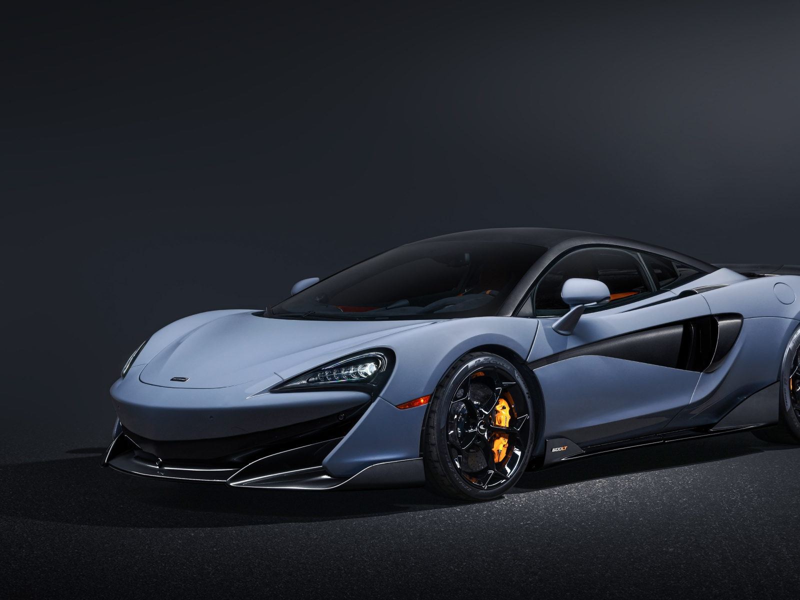 Быстрый автомобиль McLaren 600LT на черном фоне