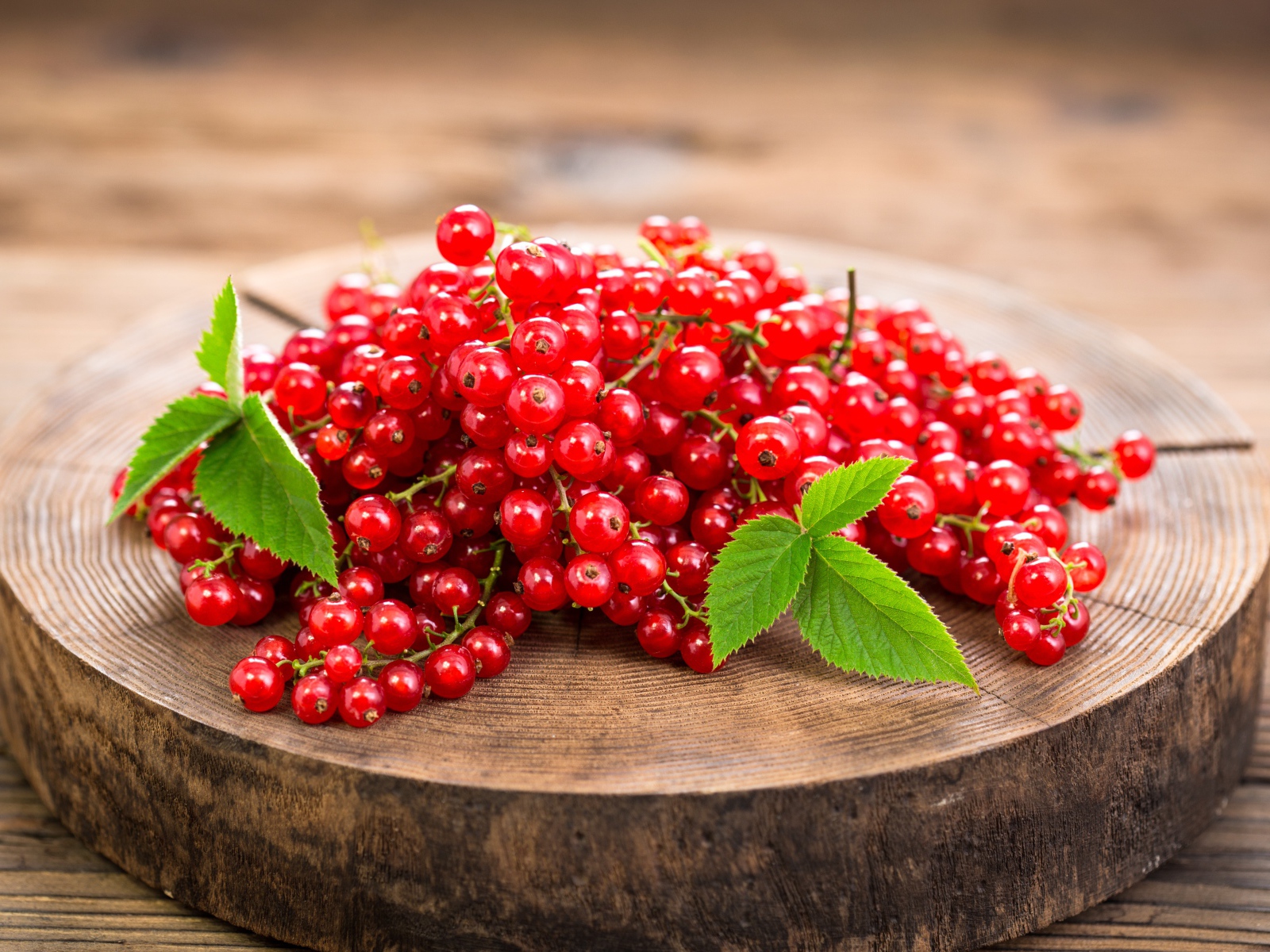 Спелая красная смородина на деревянной доске