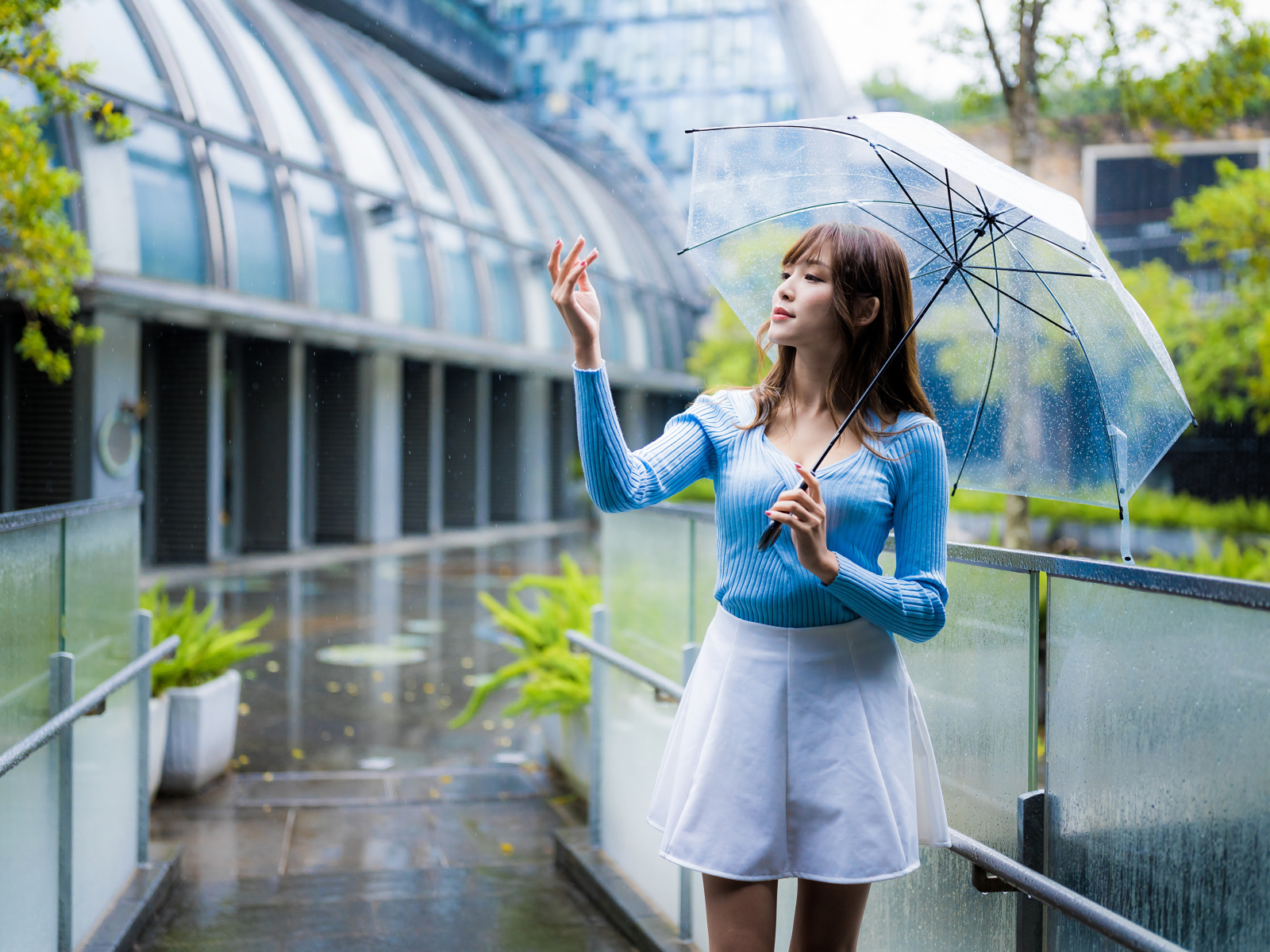 Девушка азиатка с зонтом под дождем