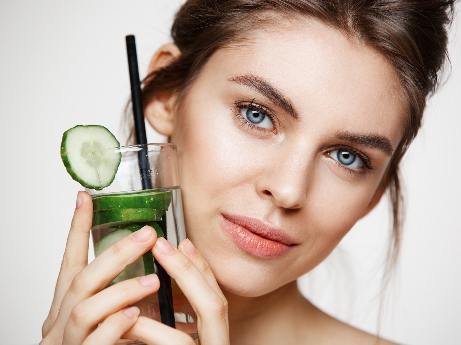 Голубоглазая девушка с огуречным напитком в руке 