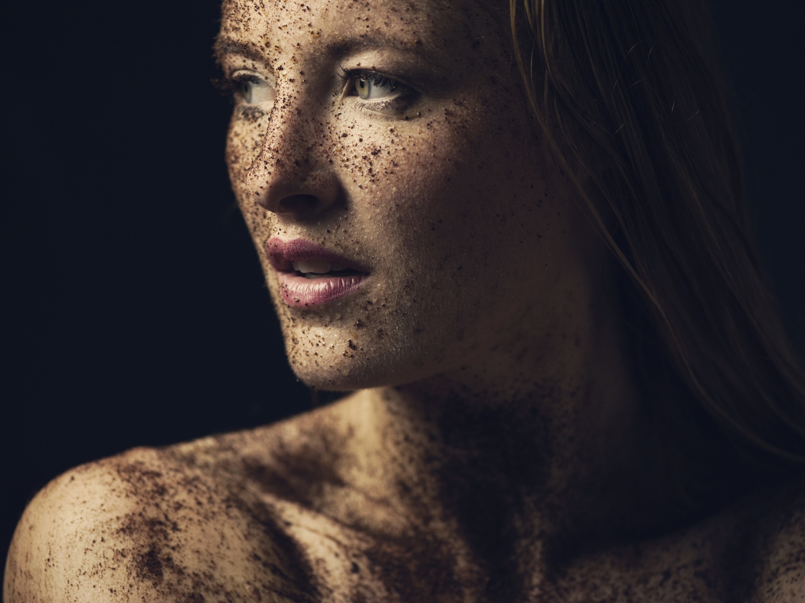 Dirty girl in the ground on black background