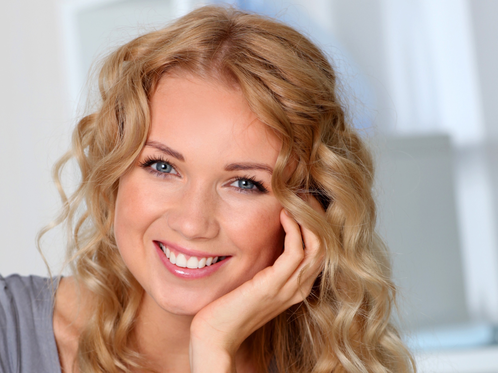 Улыбающаяся девушка в голубыми глазами 