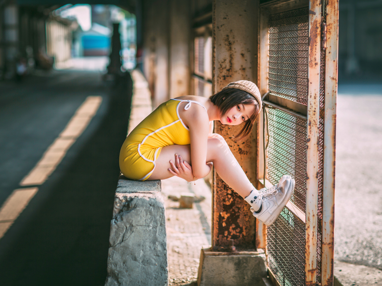 Молодая девушка азиатка сидит у сетки