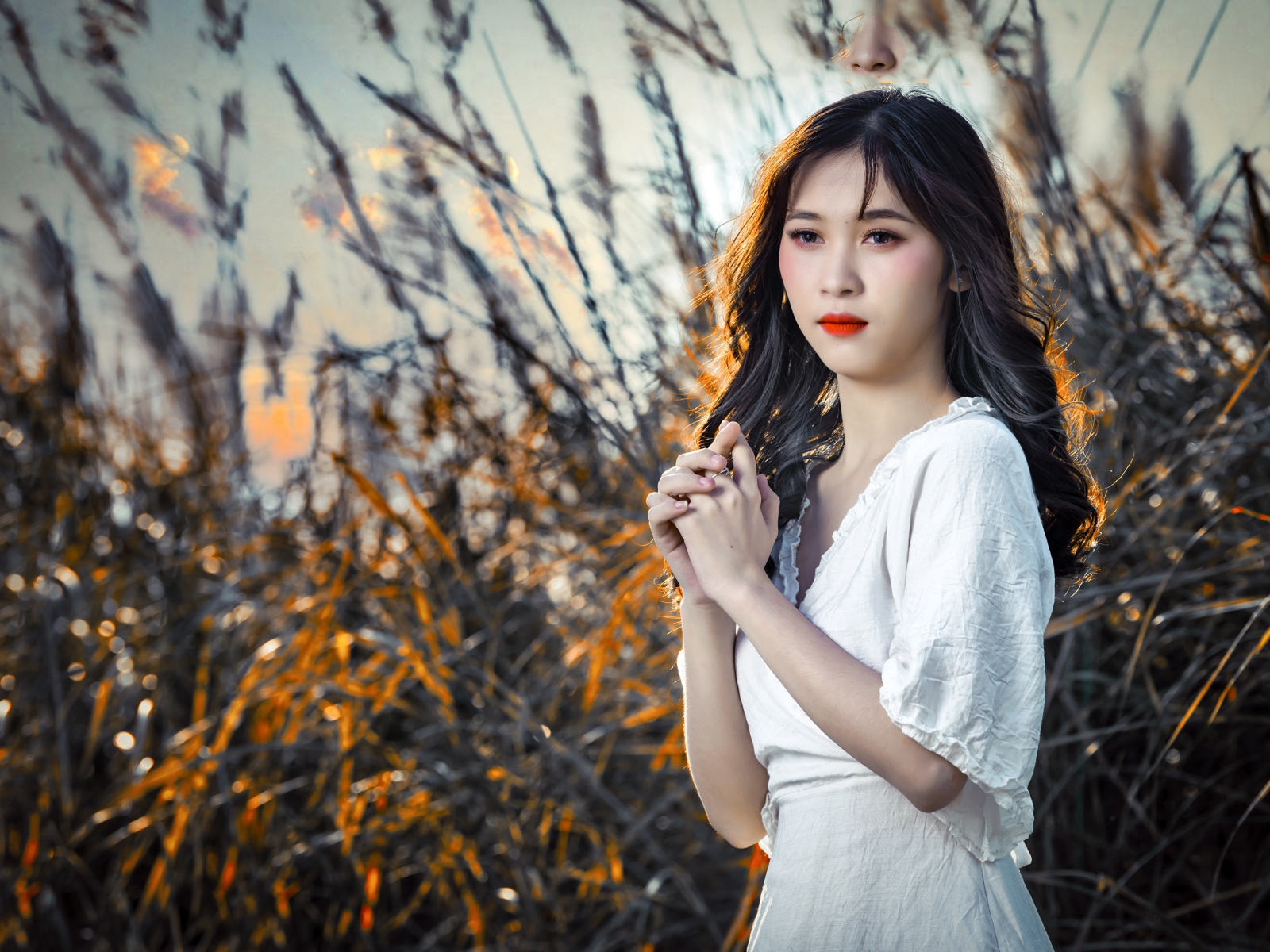 Молодая девушка азиатка в белом платье на закате