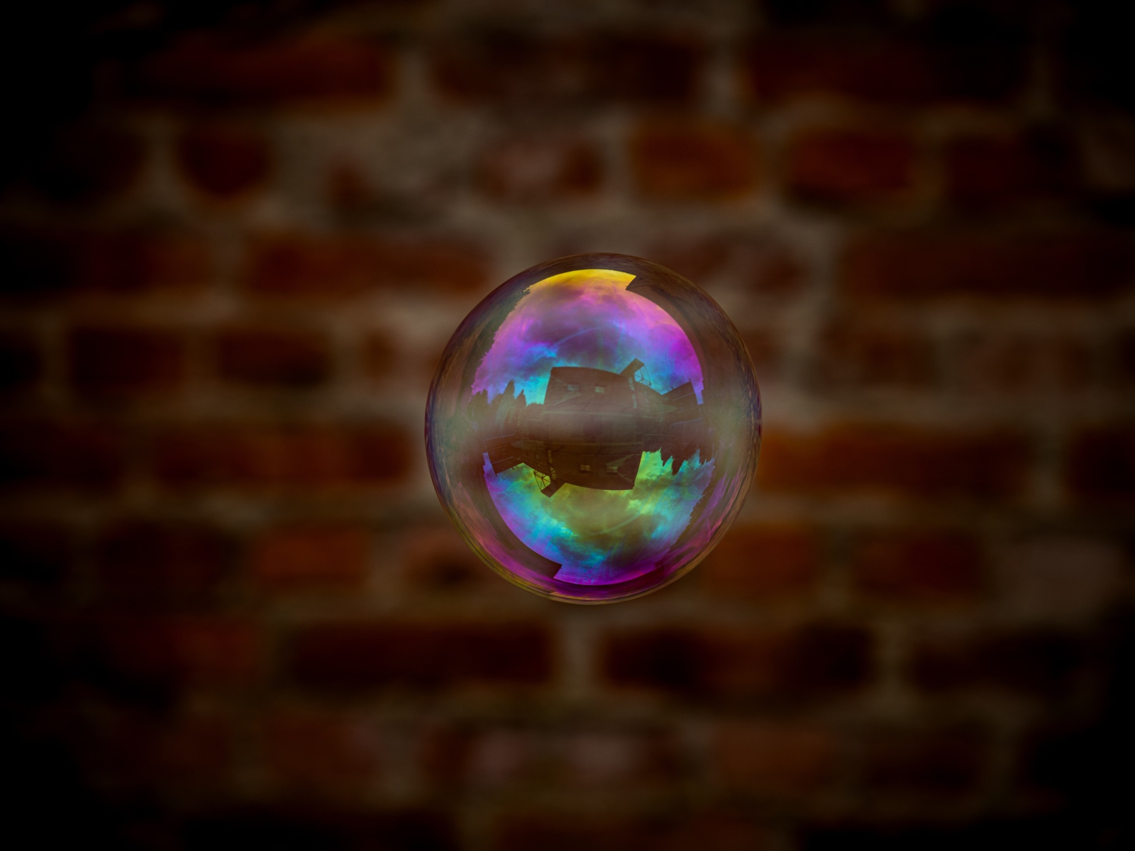 Мыльный пузырь в воздухе на фоне стены