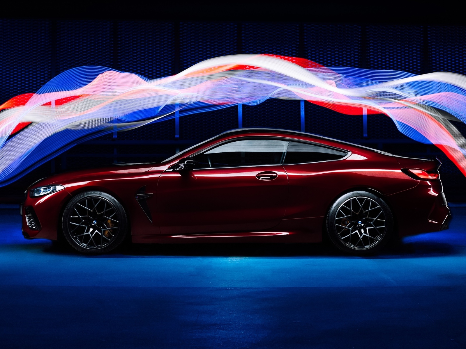 Бордовый автомобиль BMW M8 Competition оптекает волнами