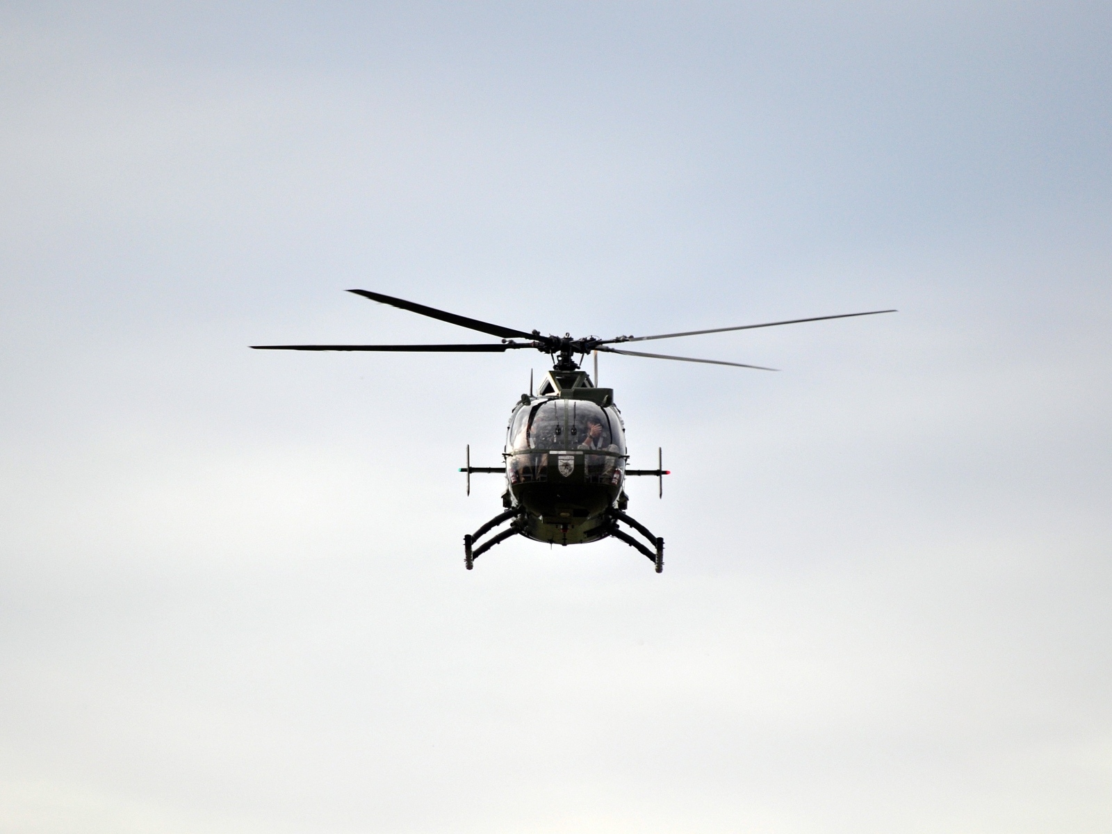 Big black helicopter flies in the sky