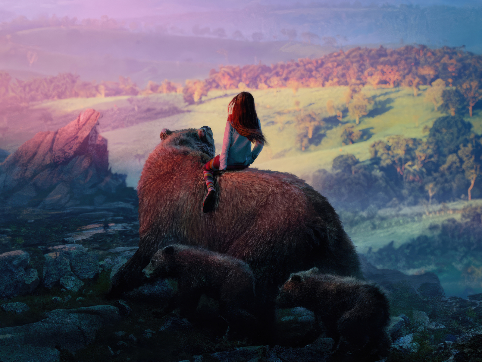 Девочка катается на большом медведе