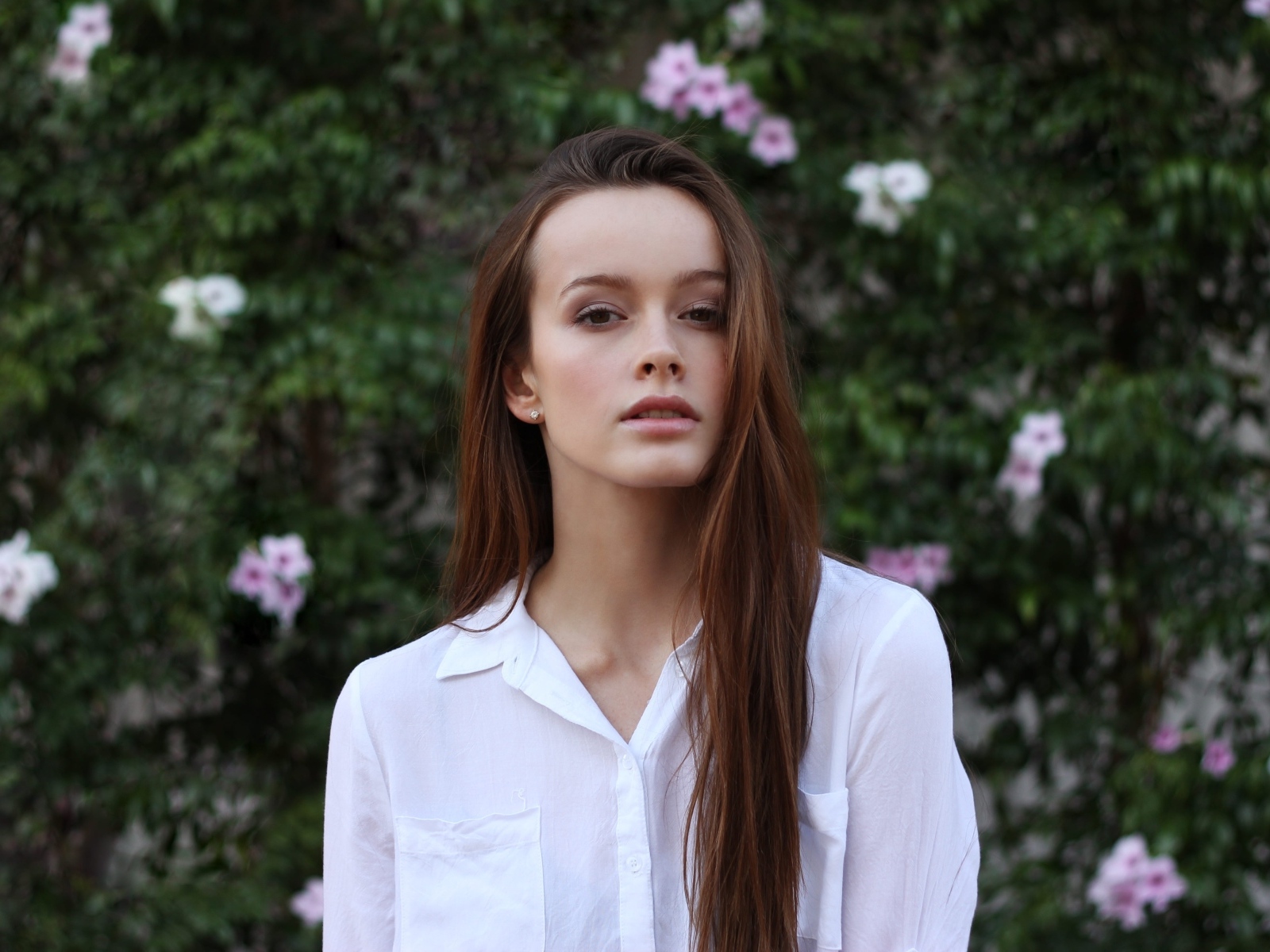 Красивая длинноволосая девушка в белой рубашке