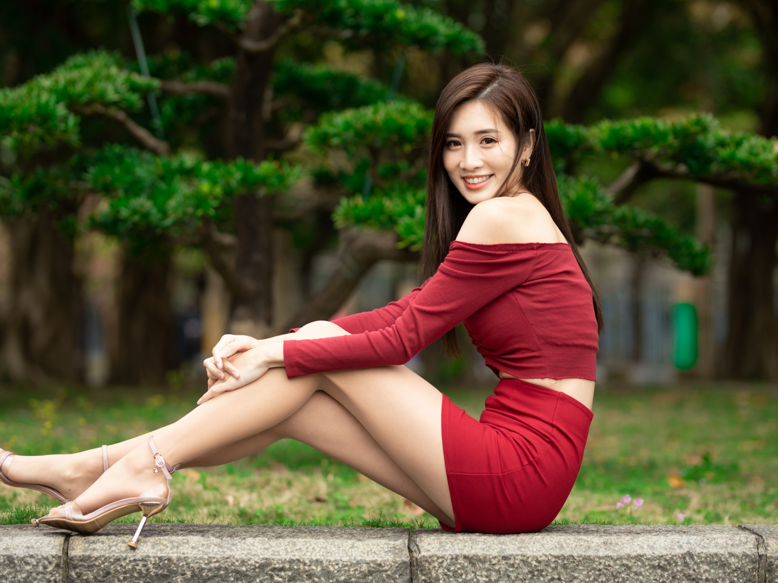 Улыбающаяся азиатка в красном костюме