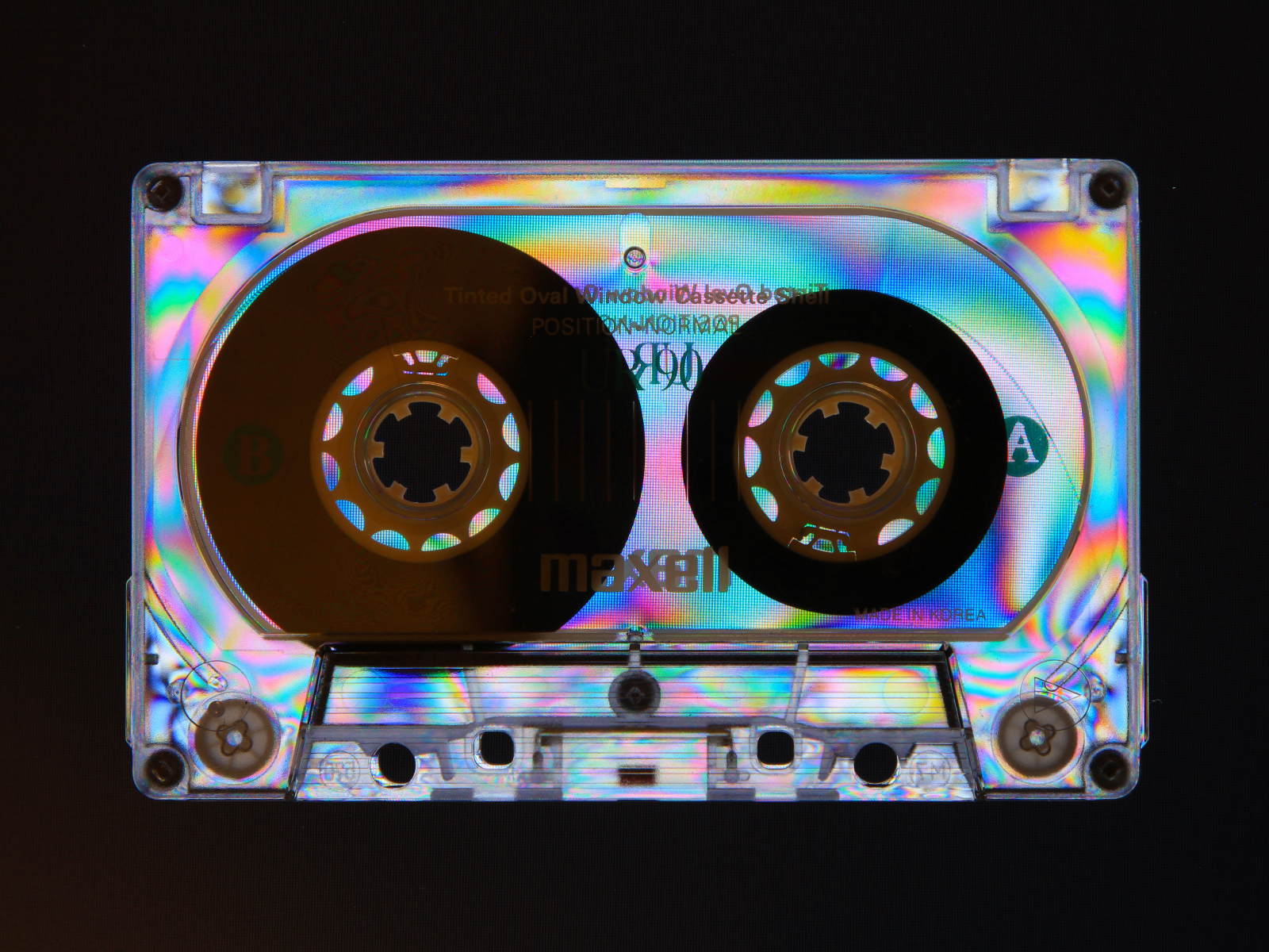 Shiny cassette tape on black background