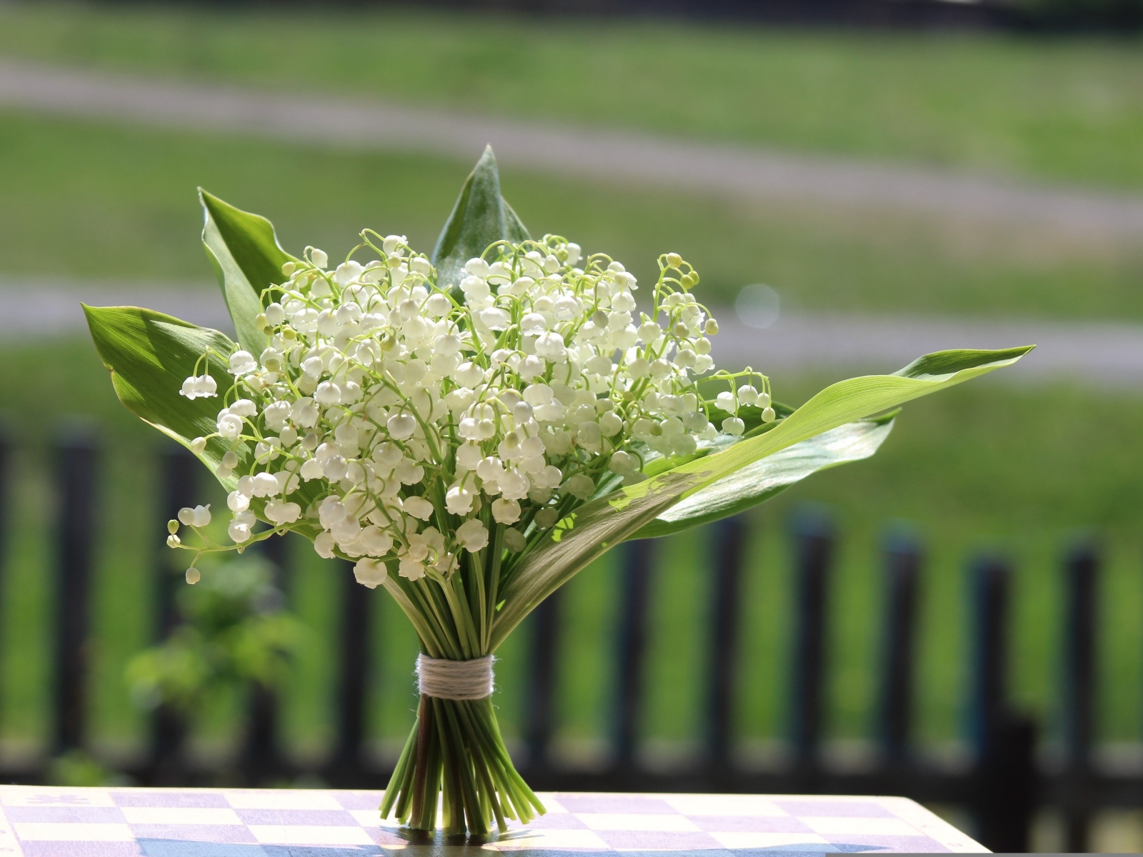 Красивый букет белых ландышей на столе в вазе