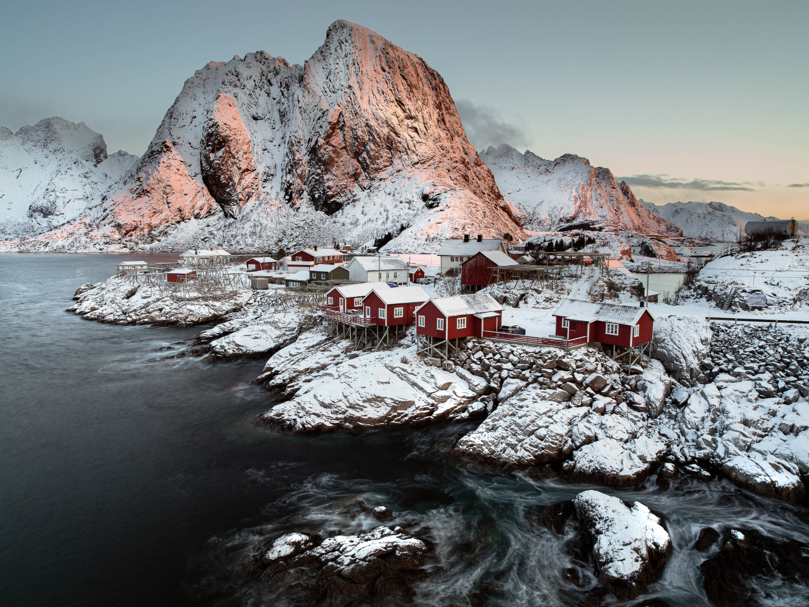 Покрытые снегом дома и гора у воды, Норвегия Лофотенские острова