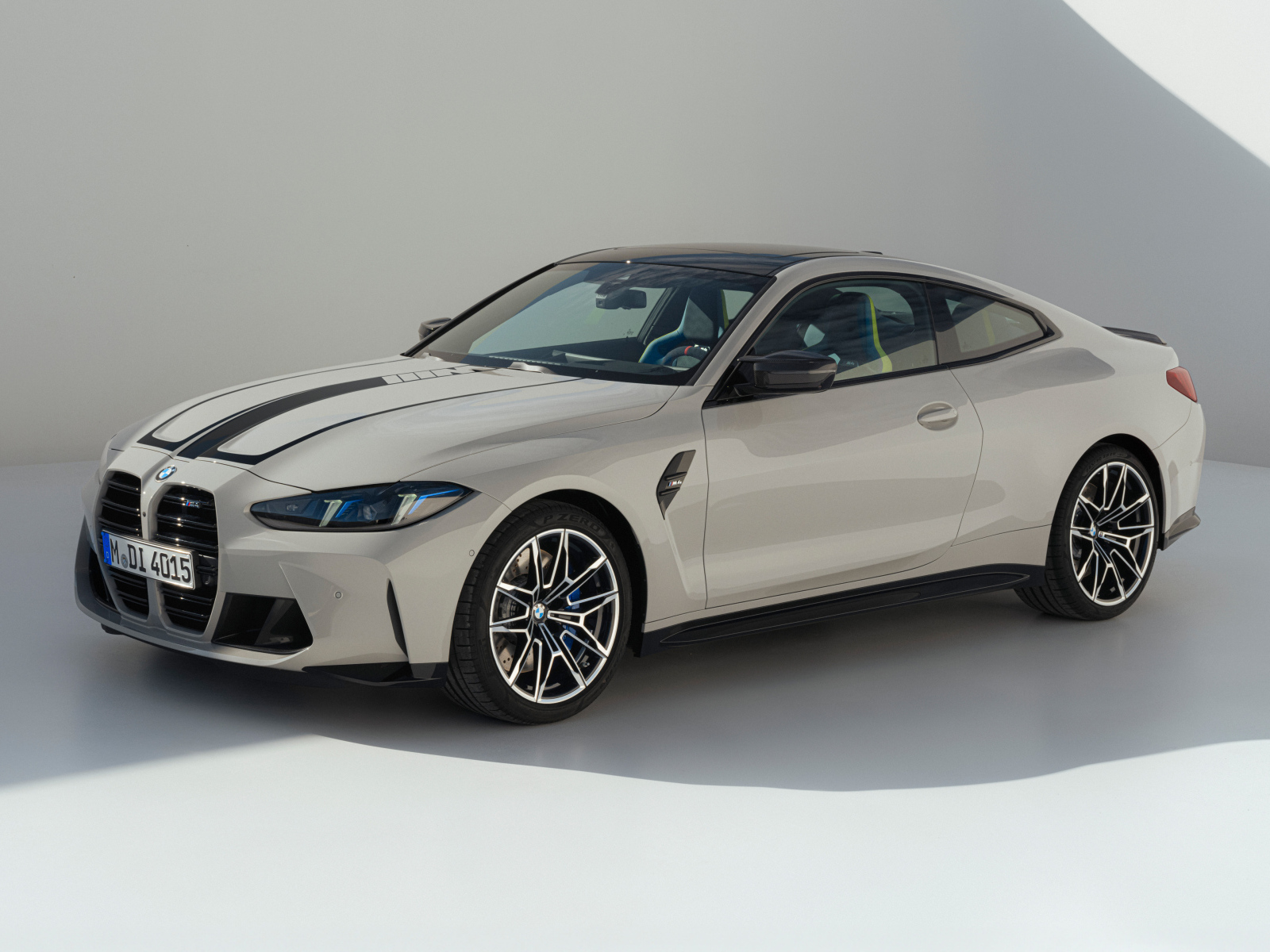 Автомобиль BMW M4 2024 года на сером фоне