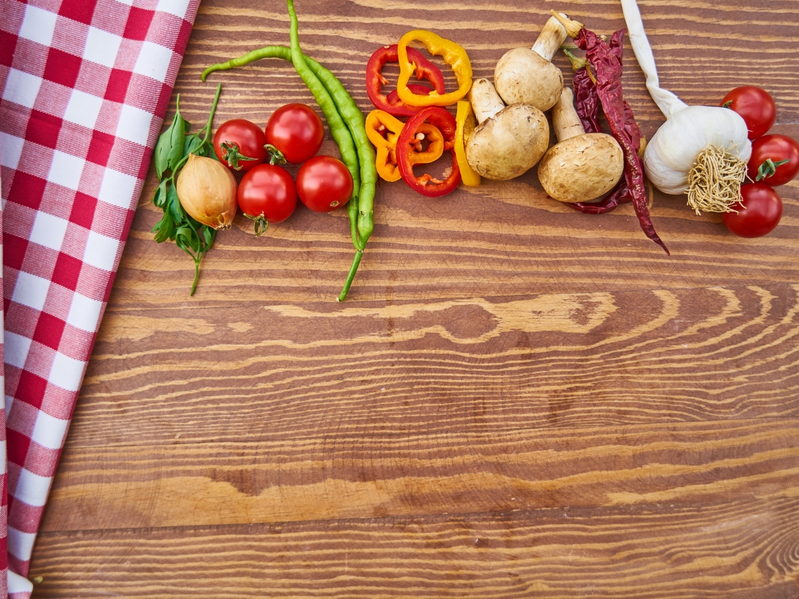 Овощи на деревянном столе с клетчатой скатертью