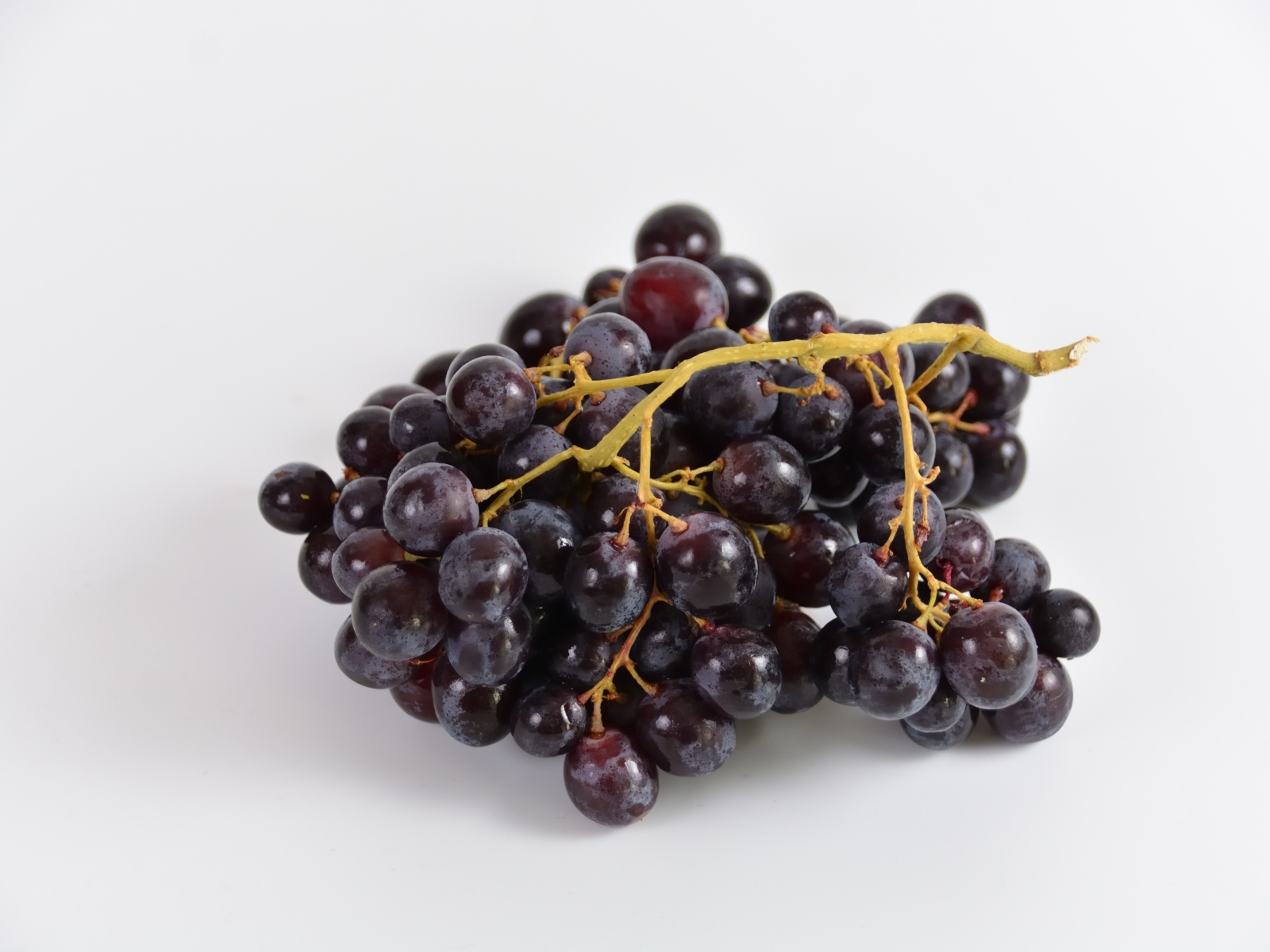 Гроздь розового винограда на сером фоне